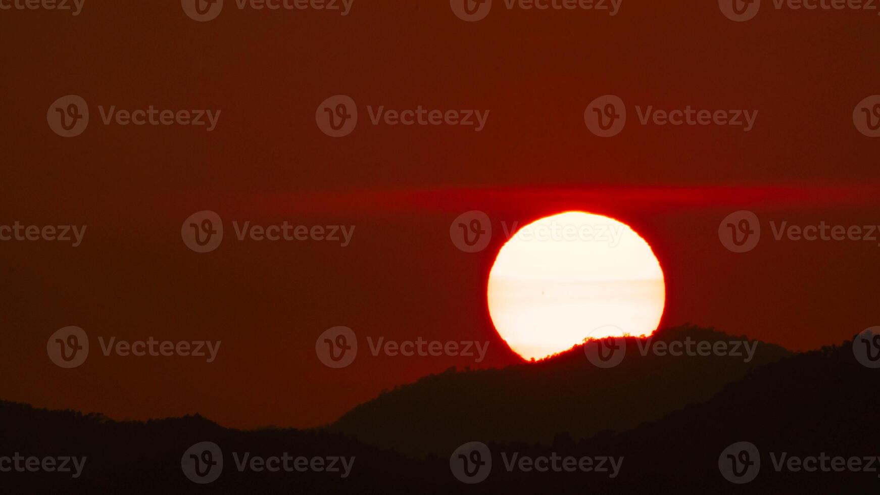 Timelapse shot of a beautiful sunrise over the horizon with an orange winter sky. Close-up of the sunrise photo