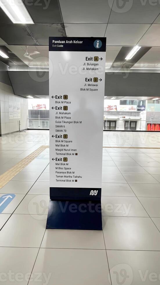 a sign for the subway station is displayed in a large building photo