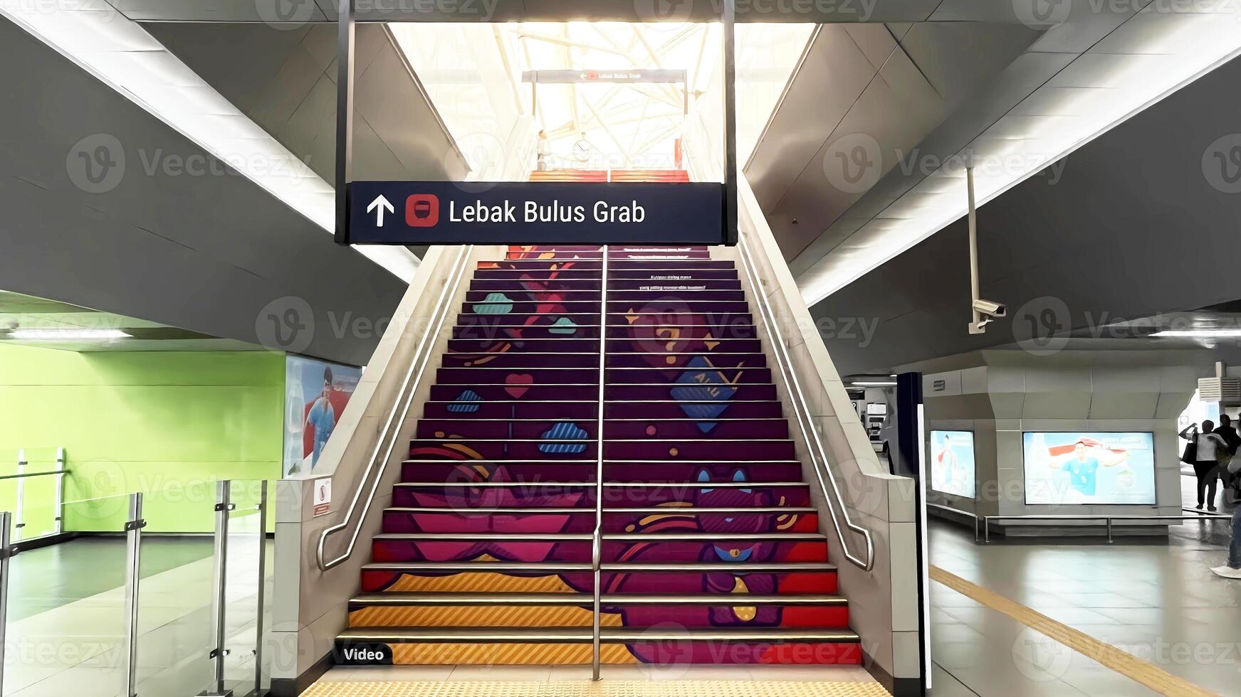 a stairway with colorful stairs and a sign. A view inside of Blok M MRT Station in Jakarta photo