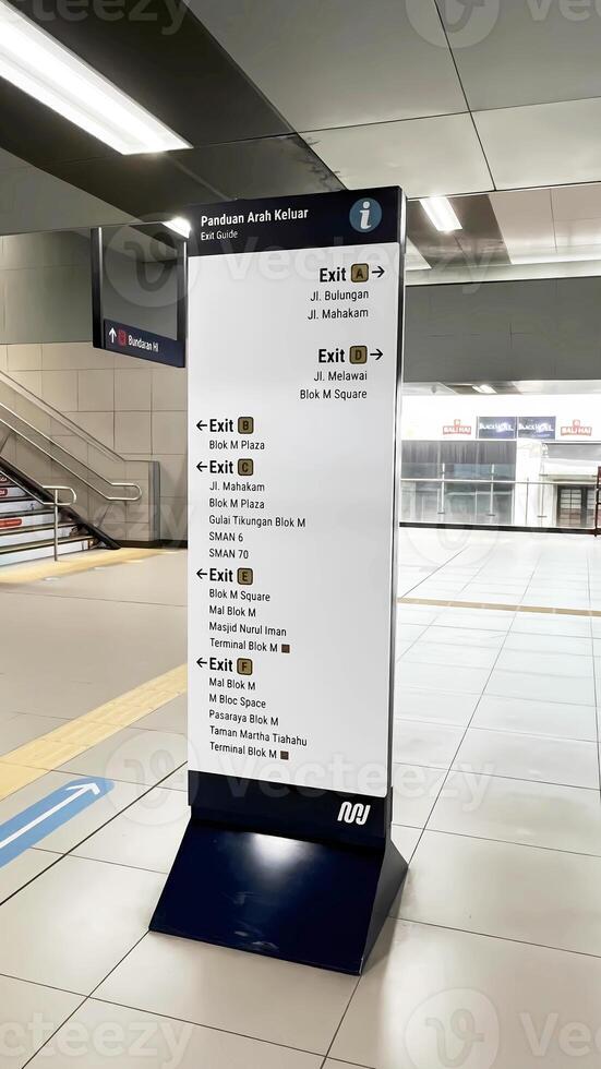 a sign for a subway station in a large building photo