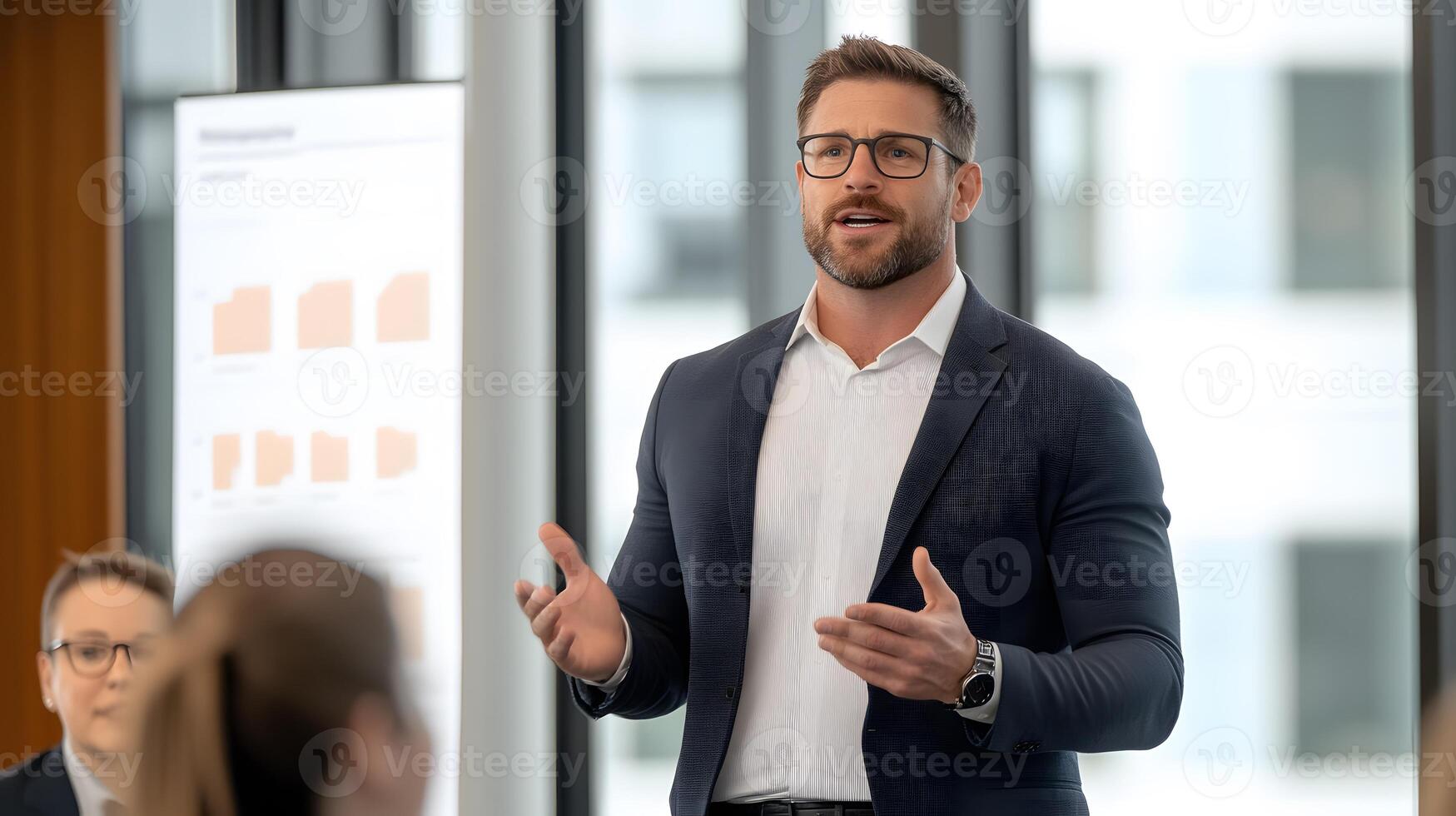 A confident leader standing at the front of a meeting room, addressing a team with a confident and engaging presentation photo