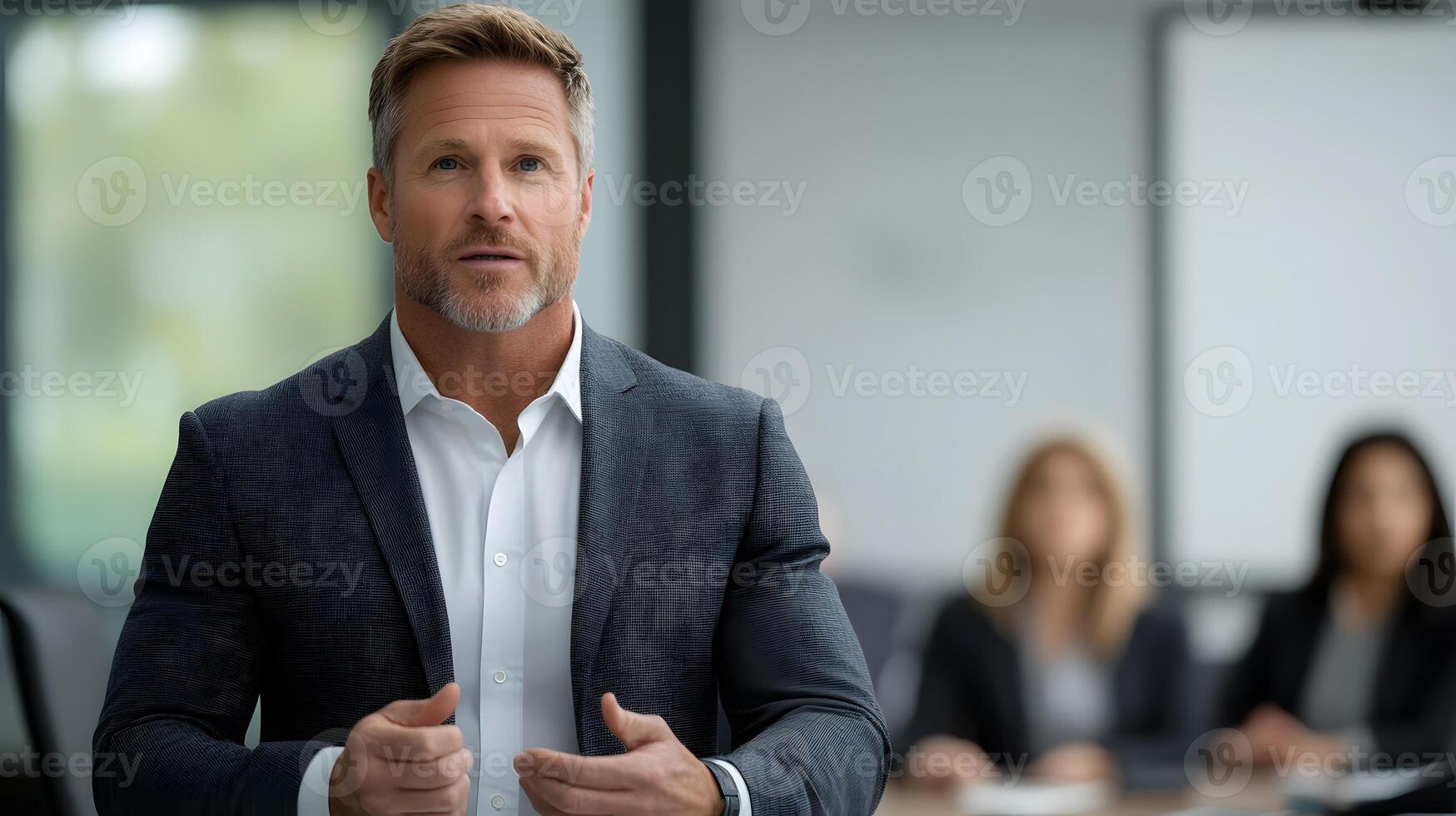A business leader giving a motivational speech to a group of professionals in a modern office setting photo