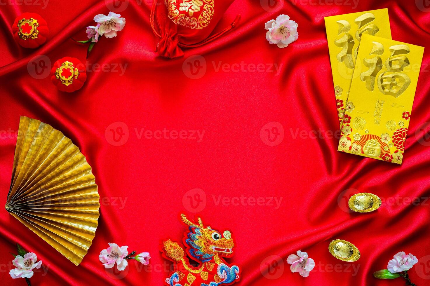 Chinese new year background with envelope packets or ang bao word mean blessing, red bag and ingots words mean wealth, hanging pendant dragon on red cloth background. photo