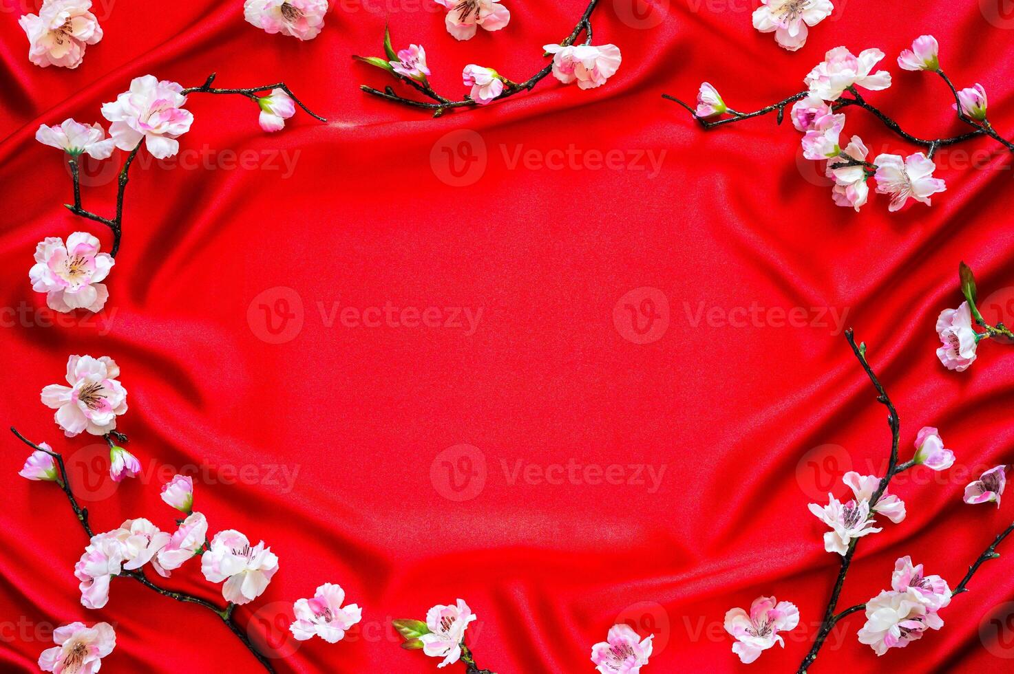 Chinese new year background with peach blossom flowers on wave and shine red satin cloth background. photo