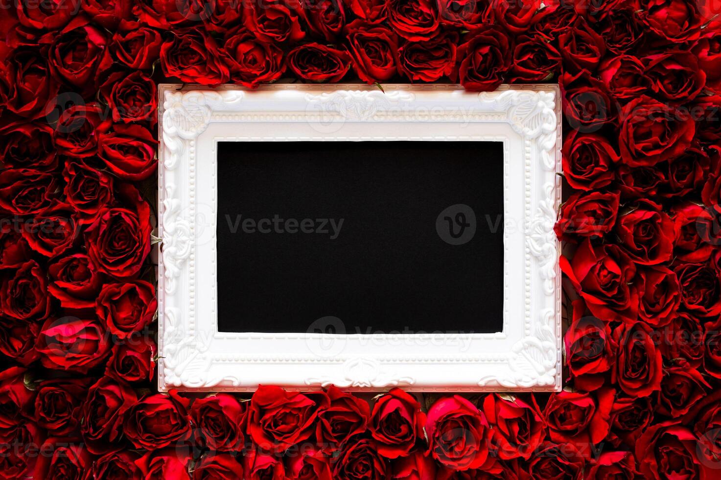 White photo frame that have black background on red roses for Valentine's and Mother day concept.