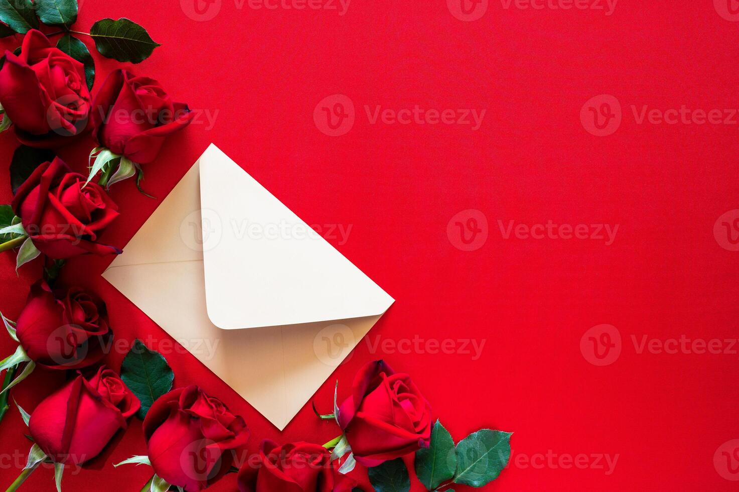 An envelope with red roses put on red background for Mother and Valentine's day concept. photo