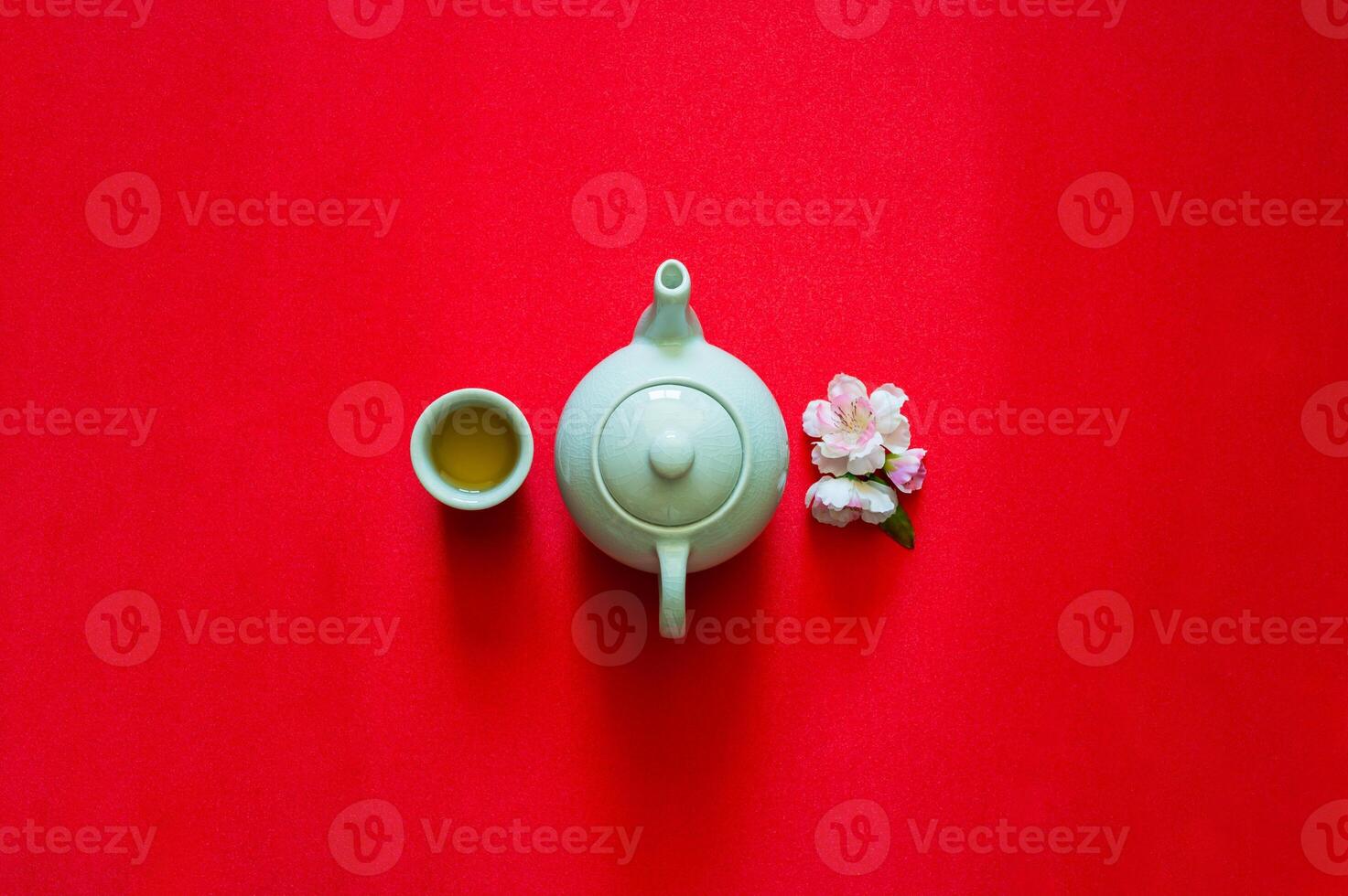 Tea set and peach blossom on red cloth background for Chinese new year concept. photo