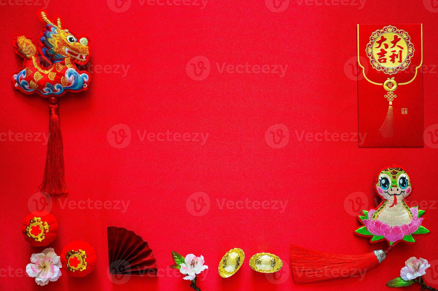 Chinese new year background with envelope packet or ang bao word mean auspicious, ingots word mean wealth, hanging pendant dragon and snake on red cloth background. photo