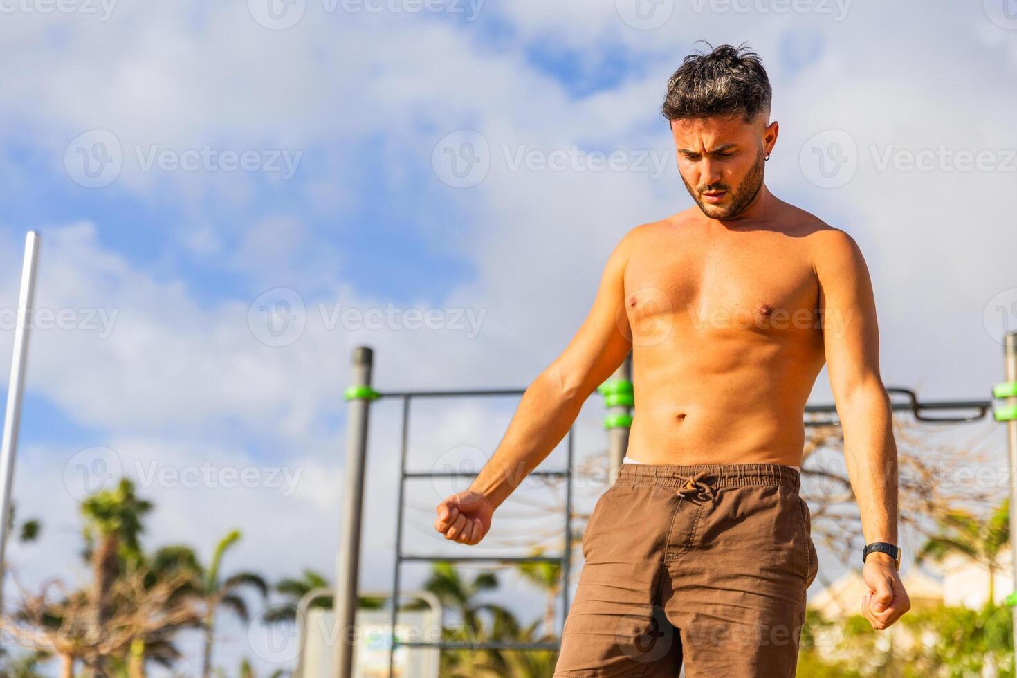 A man is warming up during a workout at the outdoor gym photo