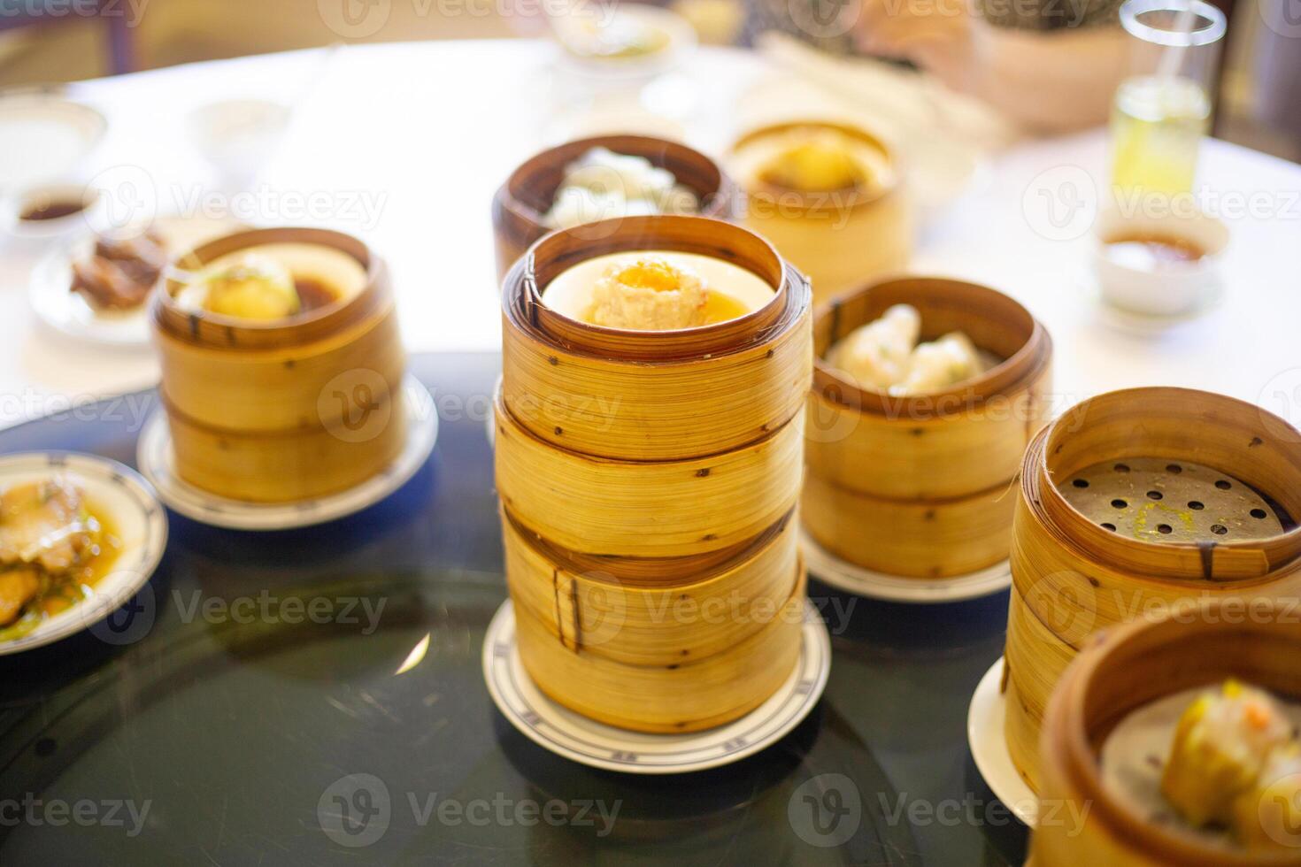Chinese cantonese dumplings dim sum pastry in the bamboo basket to cook on water steam photo