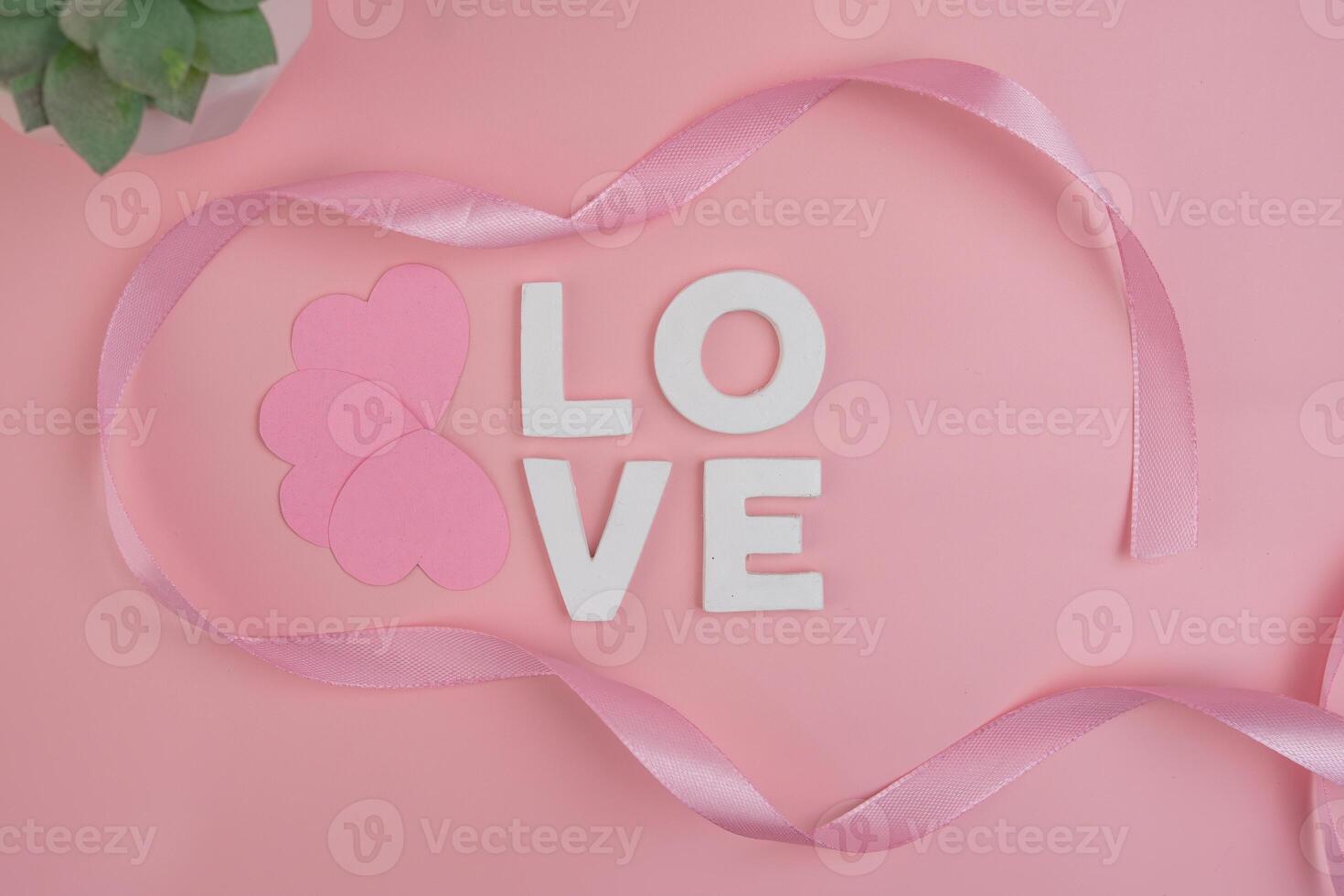 Pink hearts and ribbon surrounding the word LOVE photo