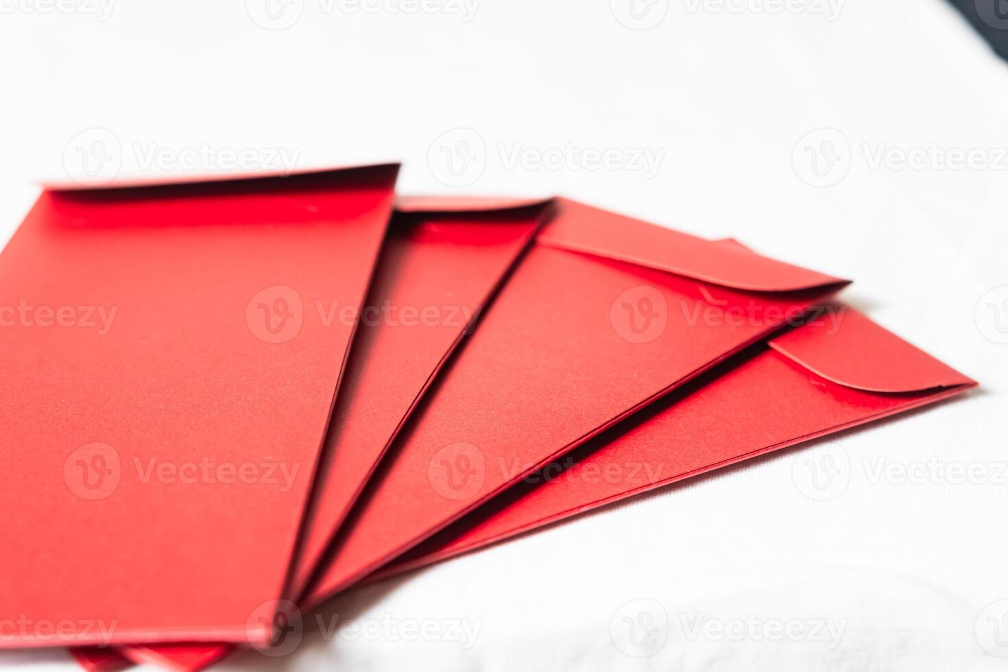 Stack of Red Envelopes on White Surface photo