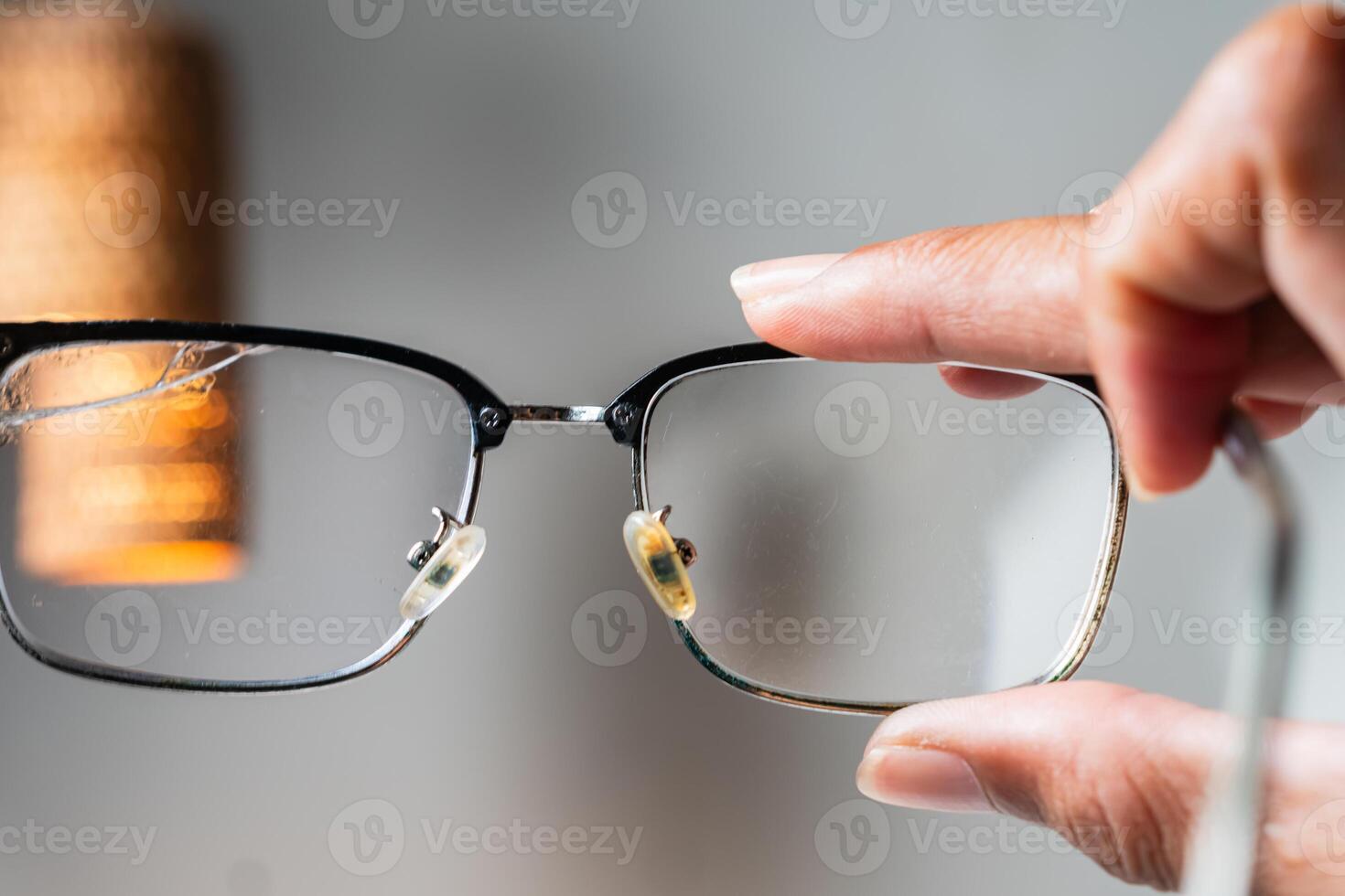 Close-Up of Eyeglasses Held by Hand photo
