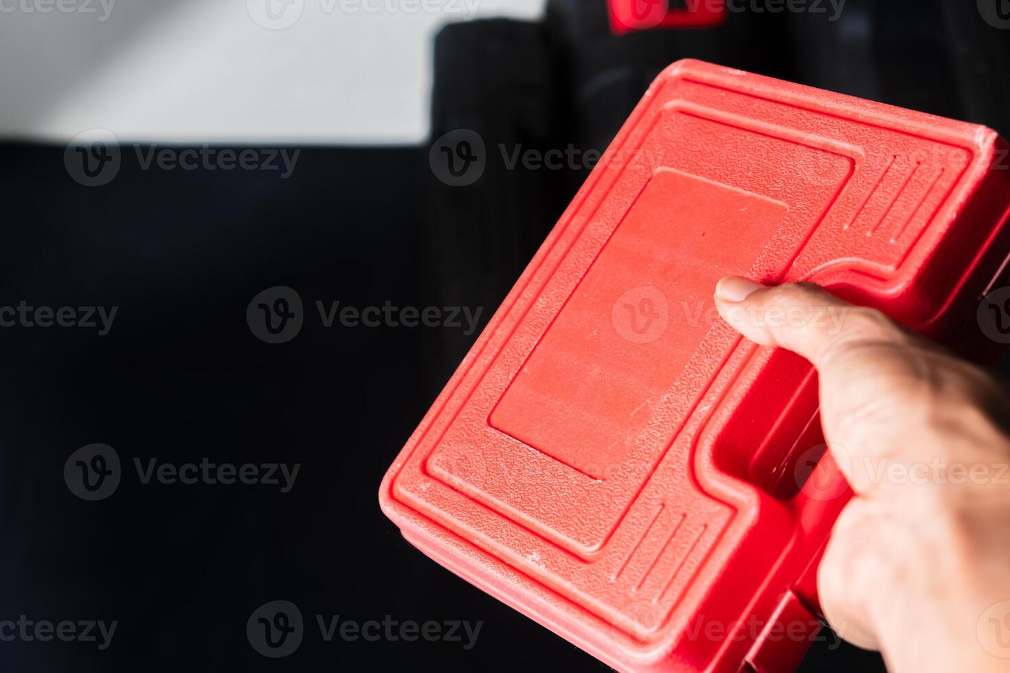 Bright Red Tool Case in Hand photo