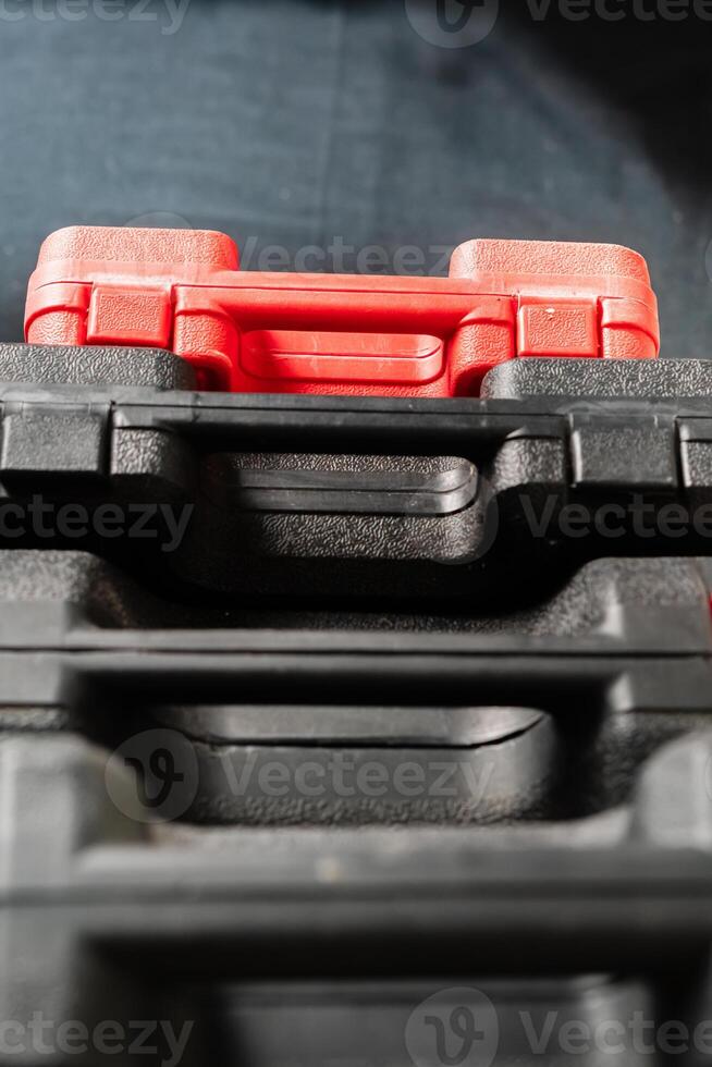 Stacked Toolboxes with a Red Toolbox on Top photo