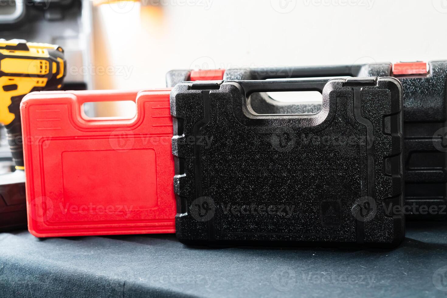 Red and Black Tool Cases on Dark Surface photo
