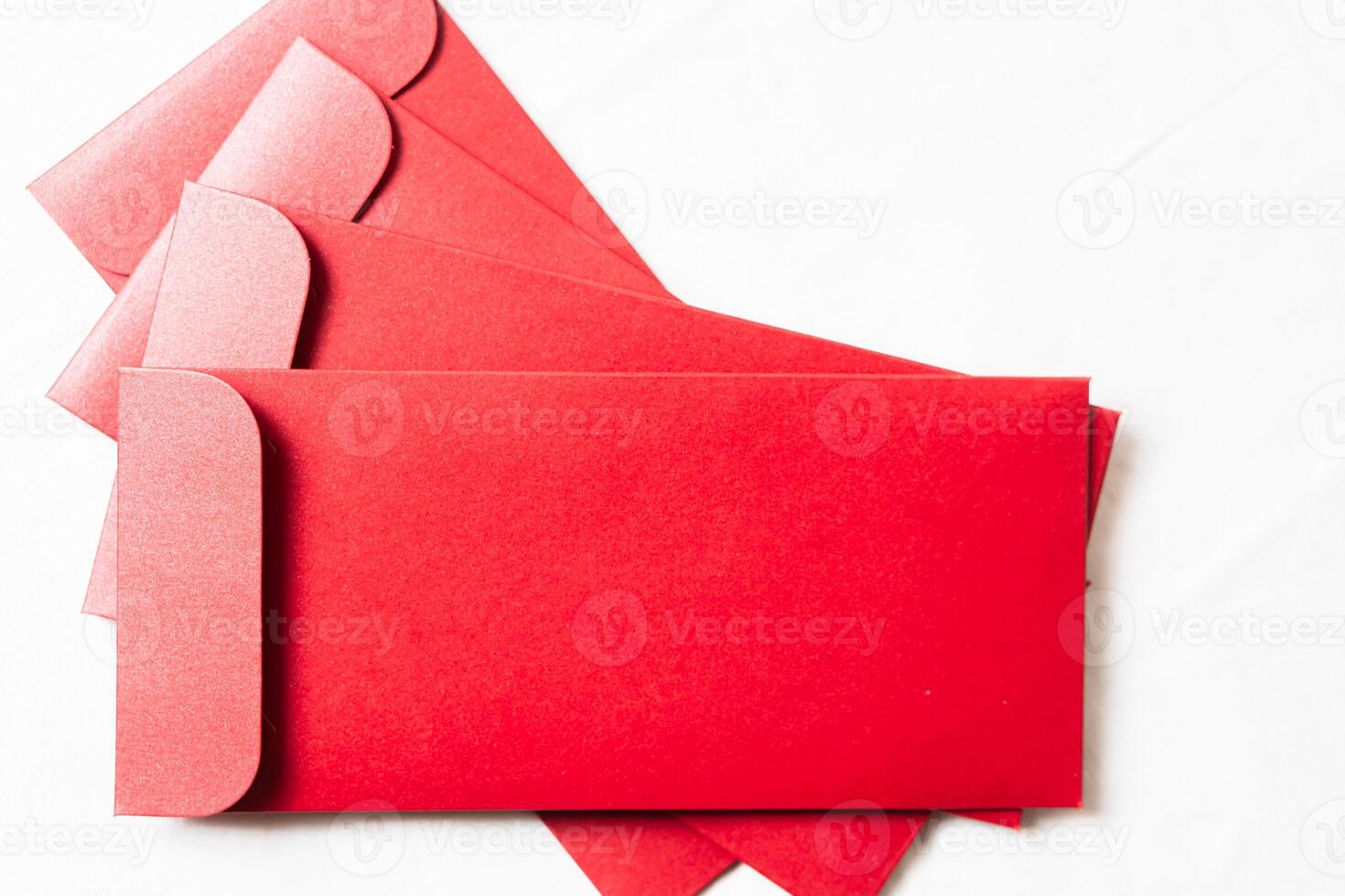 Stack of Vibrant Red Envelopes on White Surface photo