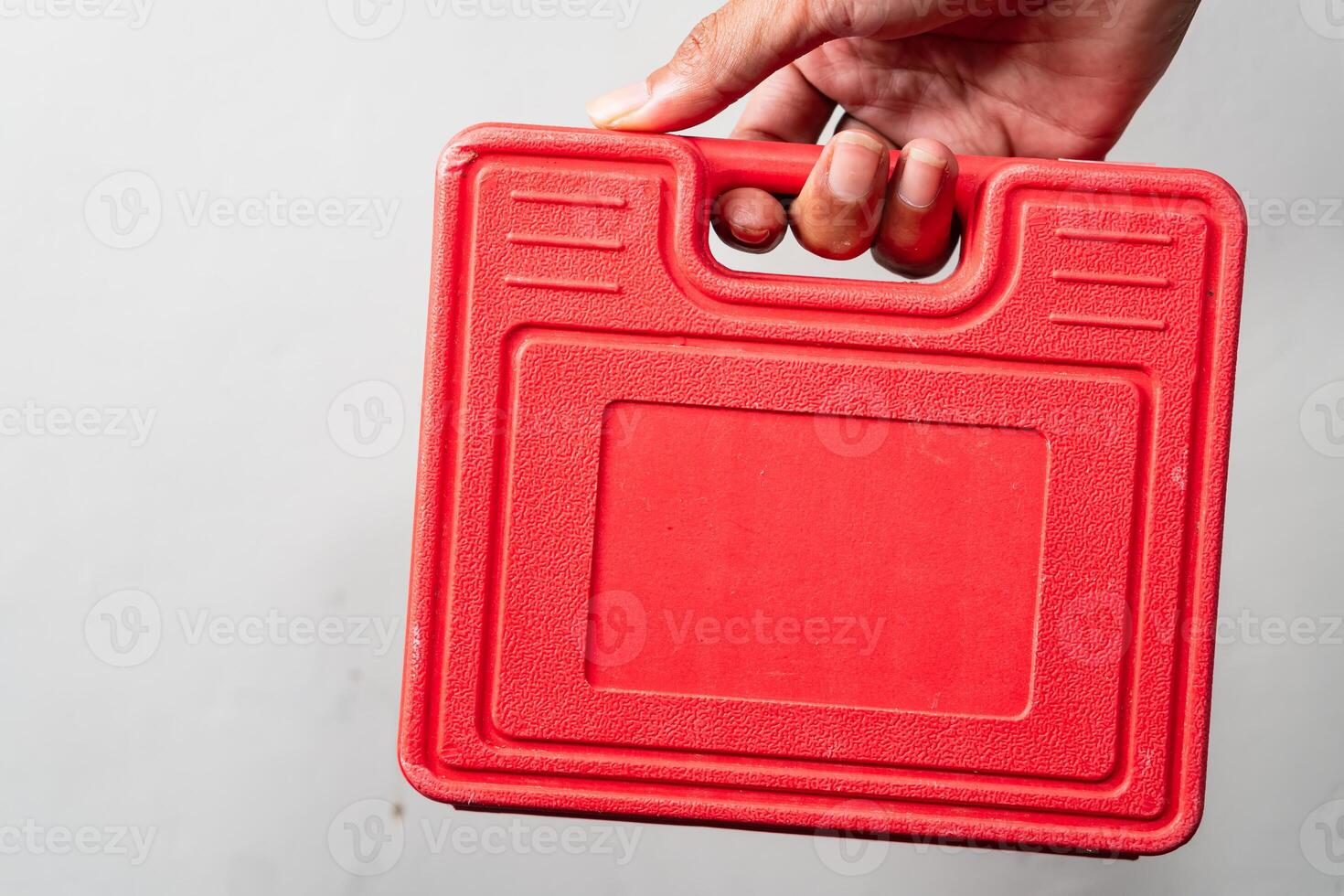 Red Plastic Toolbox Held by Hand photo