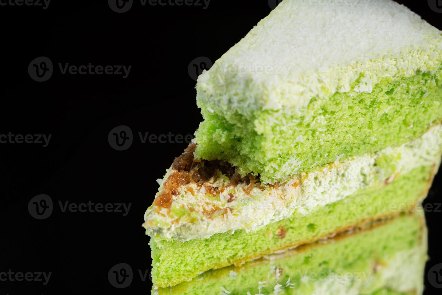 Delicious Green Cake Slice on Black Background photo