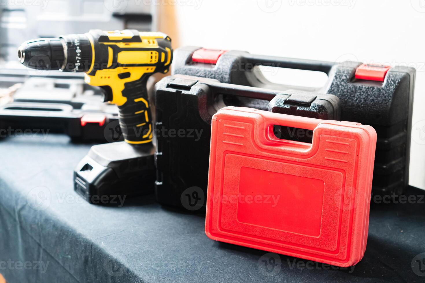 Cordless Drill and Tool Cases on Black Surface photo