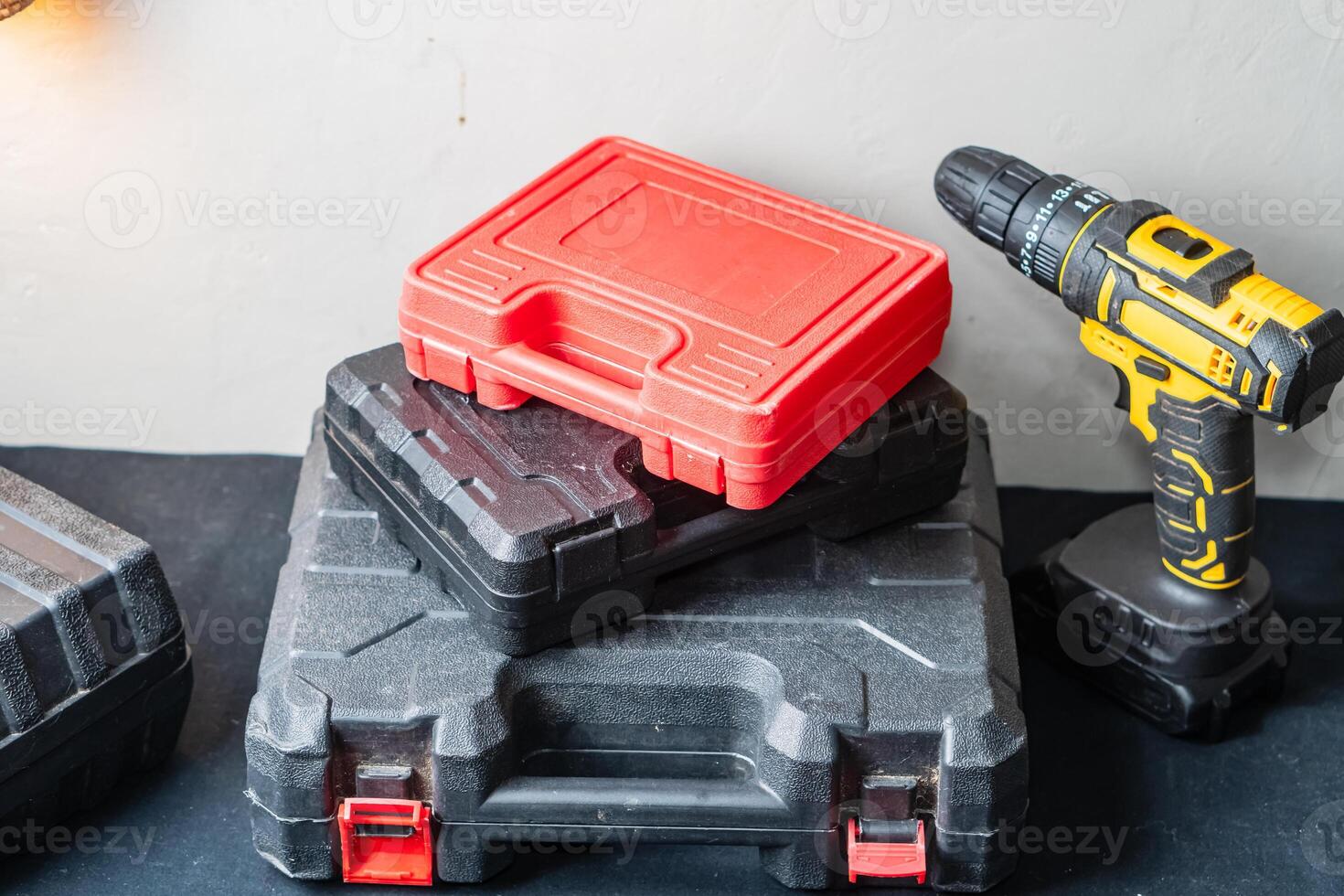 Stack of Tool Cases with Cordless Drill photo
