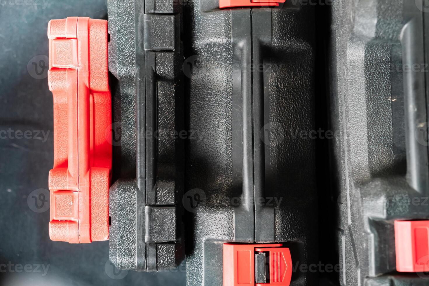 Close-up of Black Tool Cases with Red Latches photo