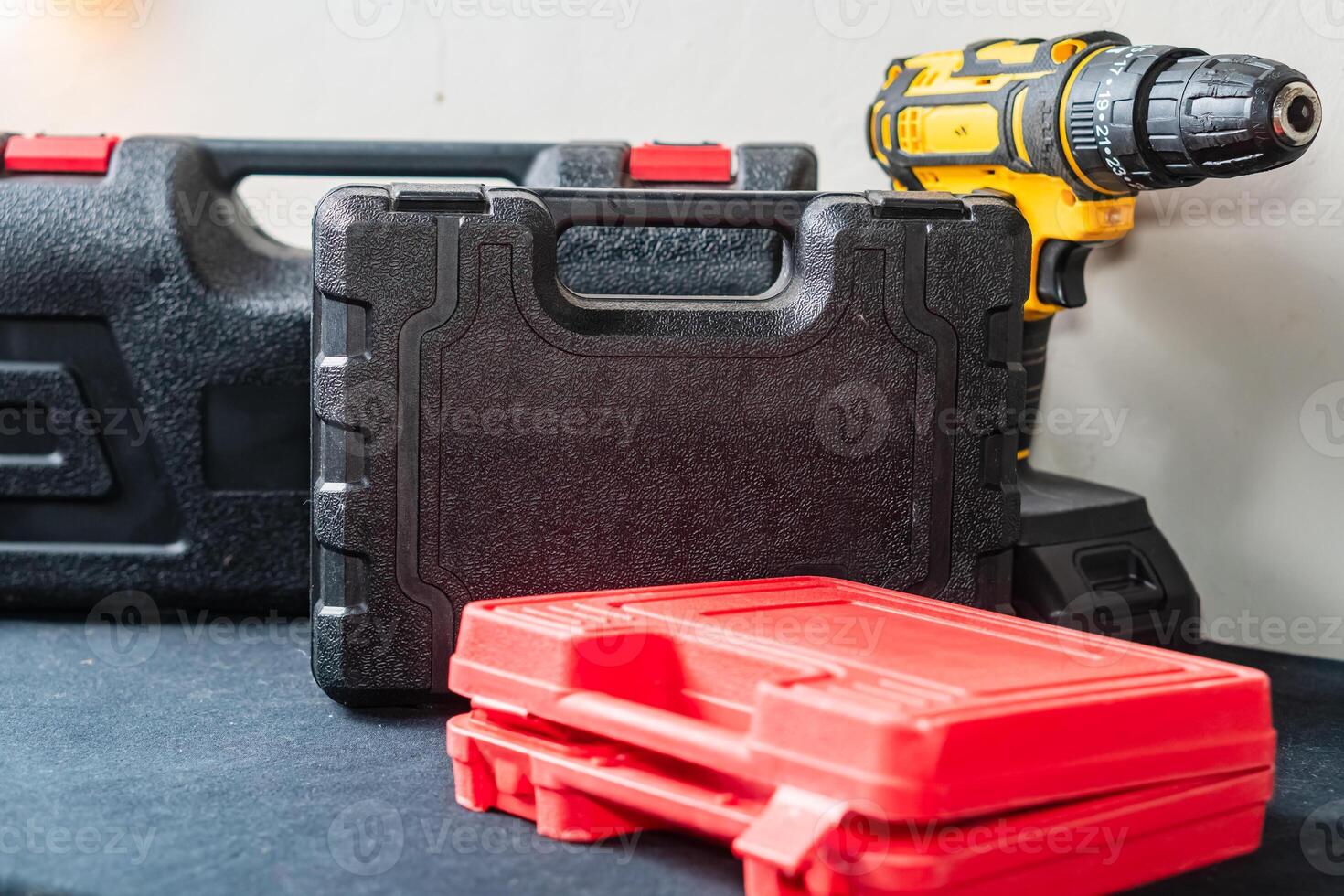 Tool Cases and Power Drill on Black Surface photo