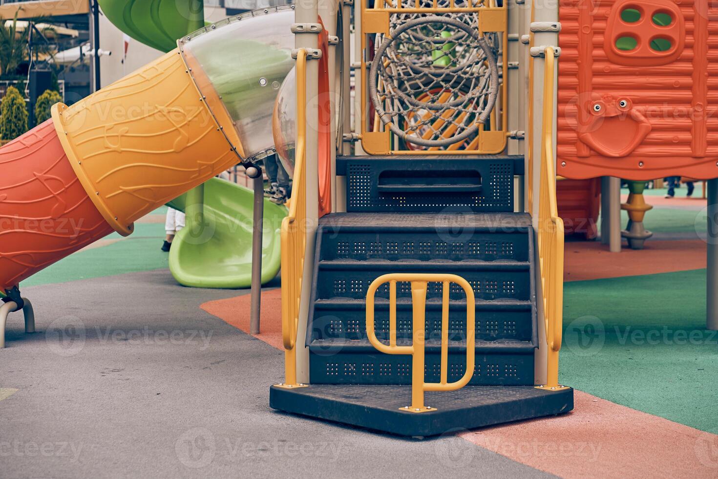 An image of a colorful playground without children. Modern slides and mazes are made of plastic. With space to copy photo