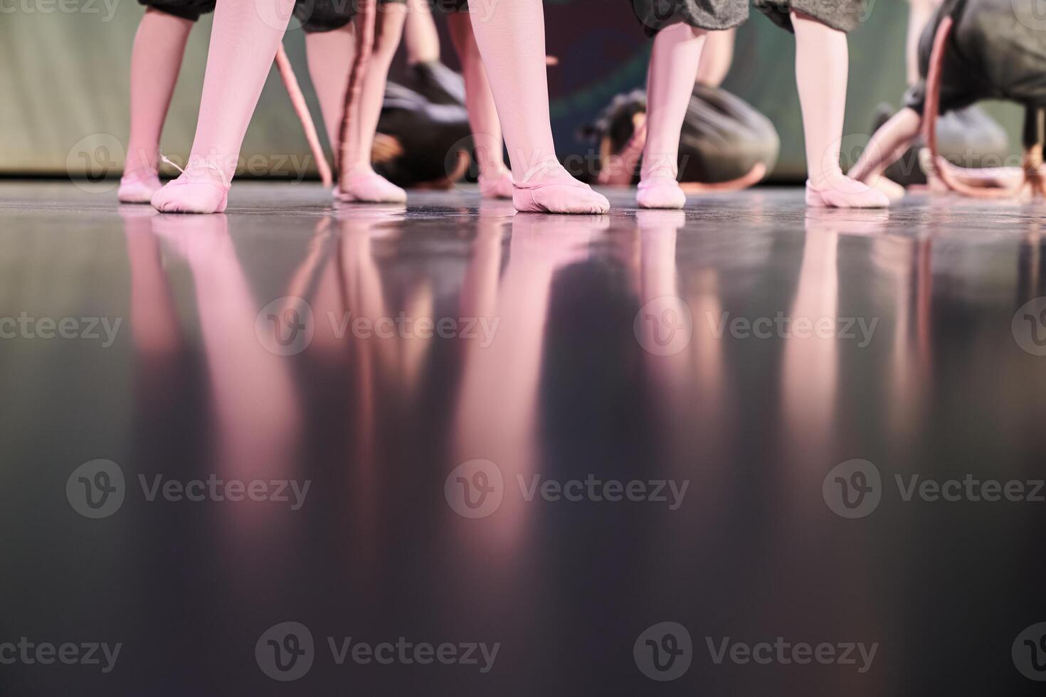 A group of dancers in different poses are standing on the stage. Children performing art on stage. Classical choreography of children, with space to copy photo