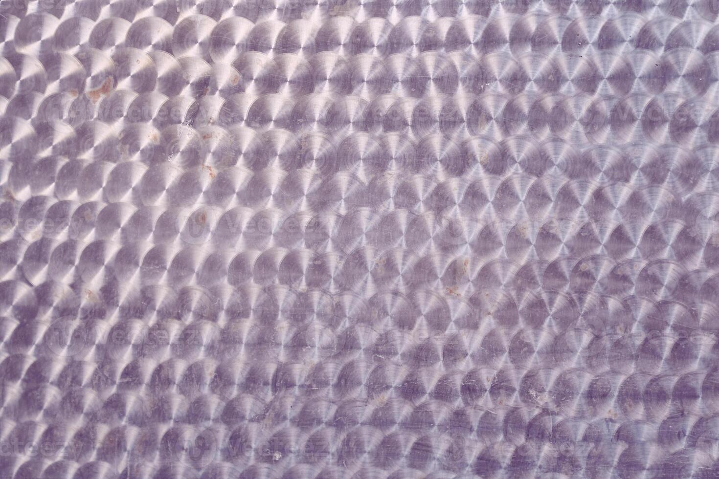A holographic surface of light lilac color with space for copying. Iridescent film texture photo
