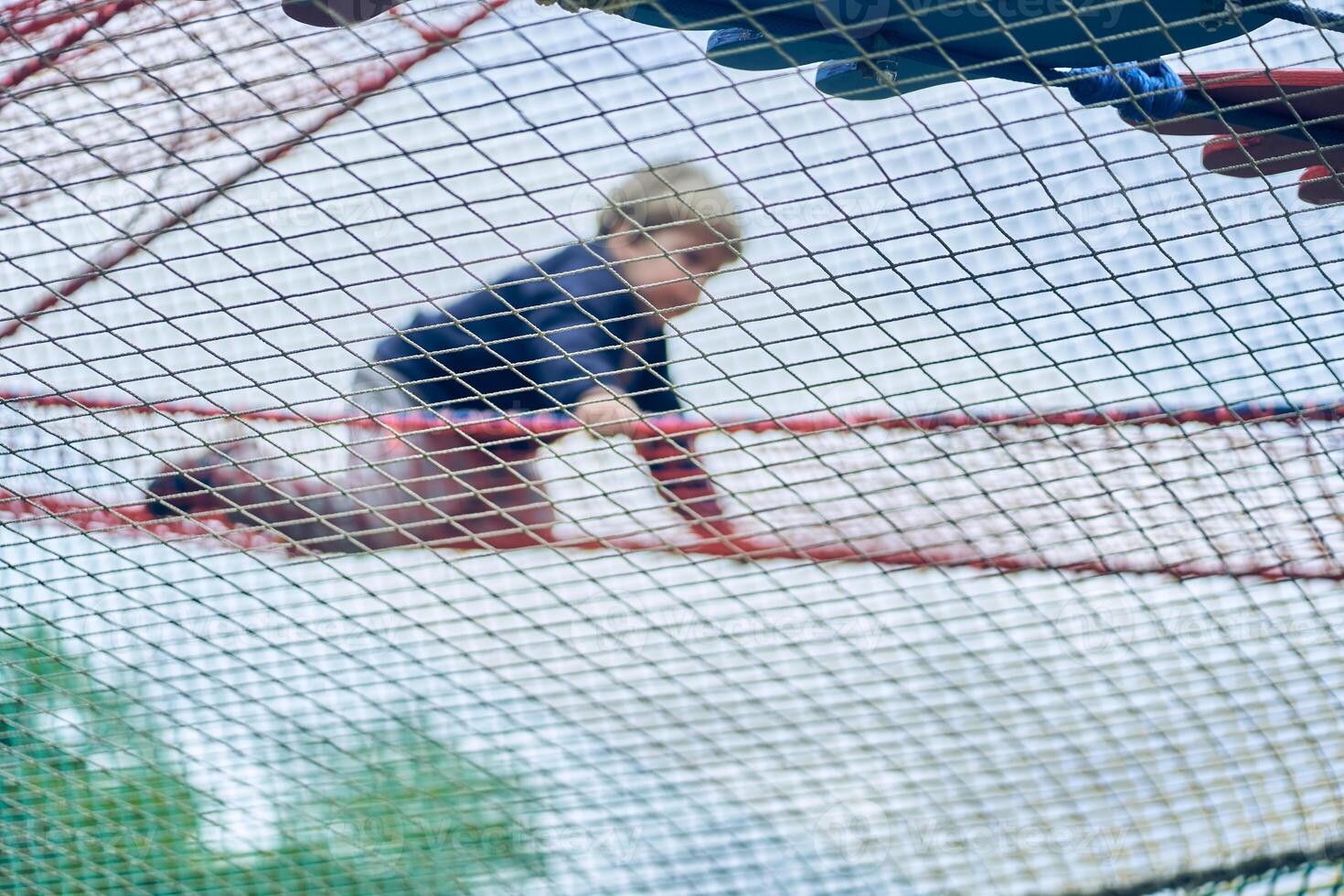 A happy boy playing in a children's maze, having fun in an entertainment center. Hobbies and entertainment. Happy child, happy childhood. The concept of summer holidays. photo
