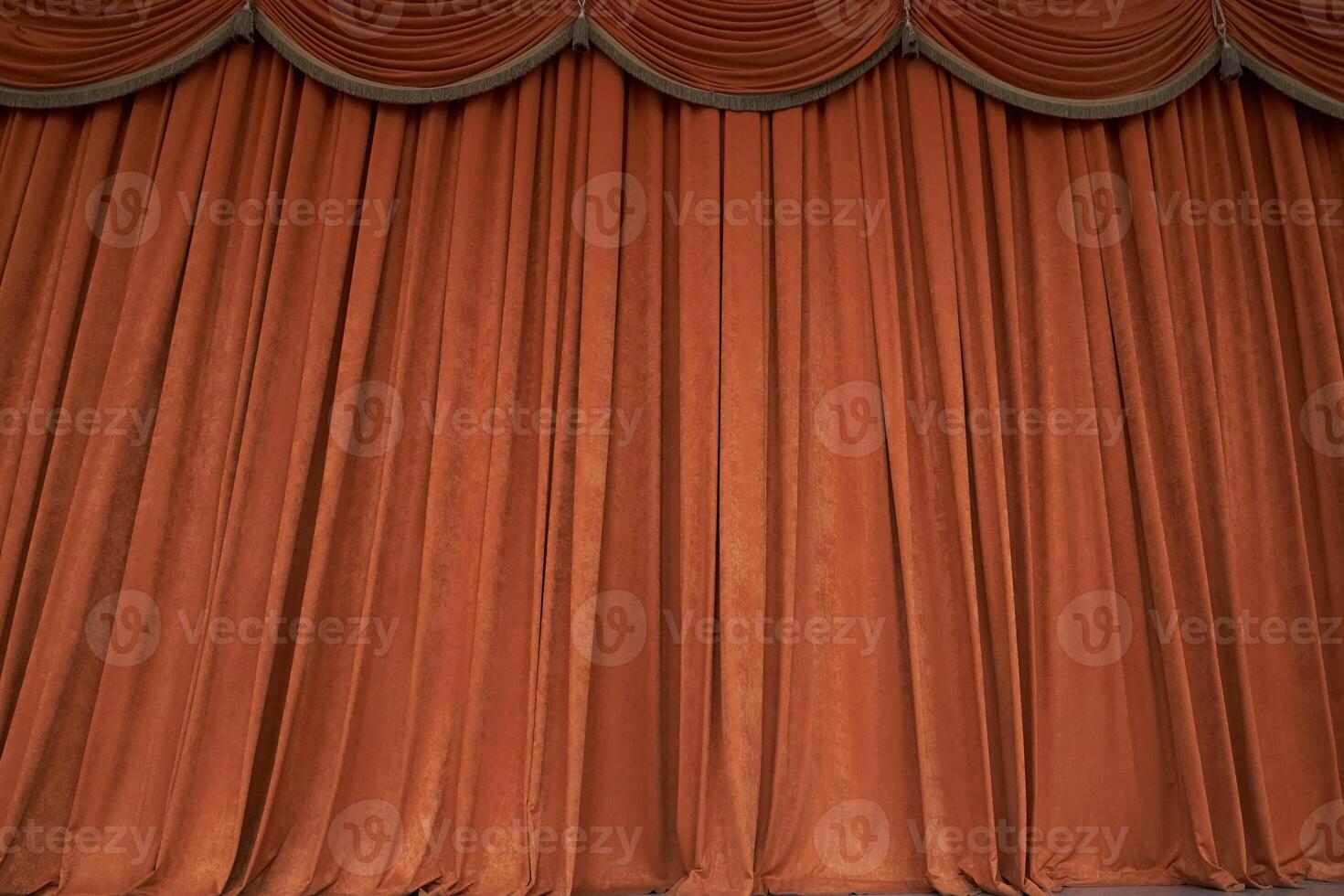 Orange closed curtain or drapes in theater with copy space. Theatrical performance concept. photo