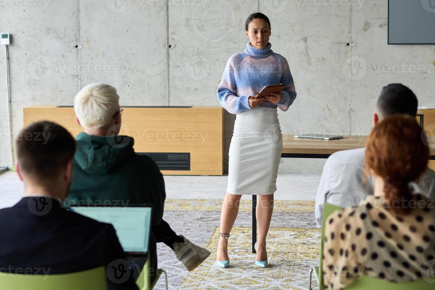 A businesswoman leader guiding a meeting with her colleagues, discussing business challenges, marketing strategies, and new plans for growth and success photo