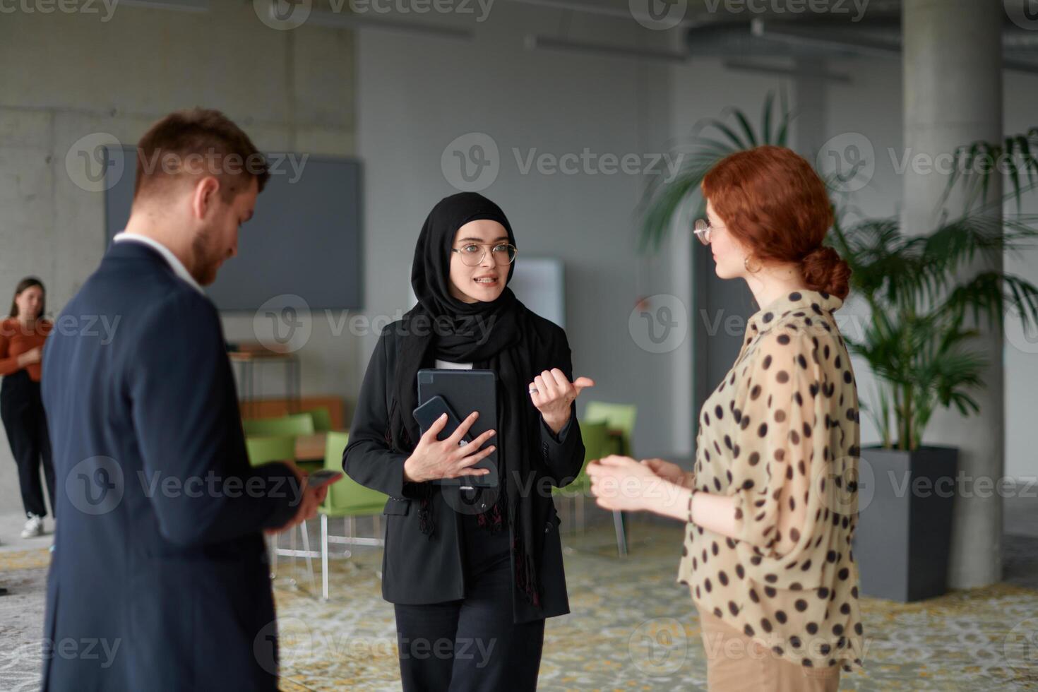 A business team engages in a lively discussion during a coffee break, exchanging challenges and sharing moments of laughter, fostering a positive and collaborative work environment photo