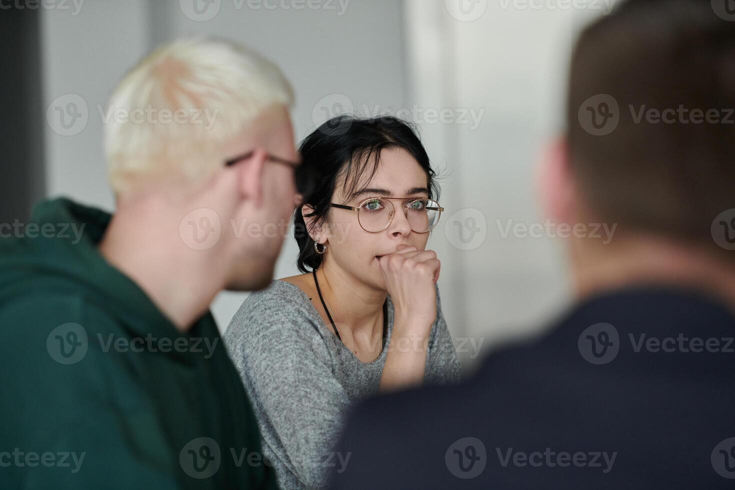 A diverse multiethnic business team engages in a collaborative meeting, discussing strategies and solutions in a modern office setting photo