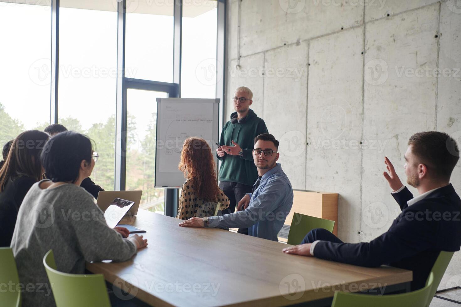 A diverse multiethnic business team engages in a collaborative meeting, discussing strategies and solutions in a modern office setting photo
