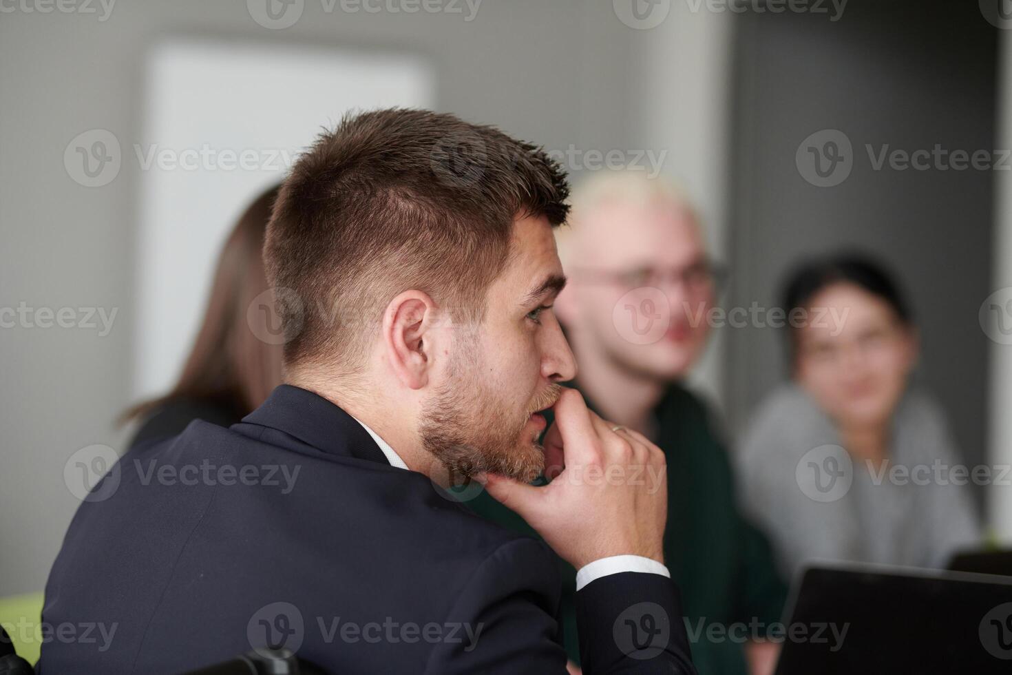 A diverse multiethnic business team engages in a collaborative meeting, discussing strategies and solutions in a modern office setting photo