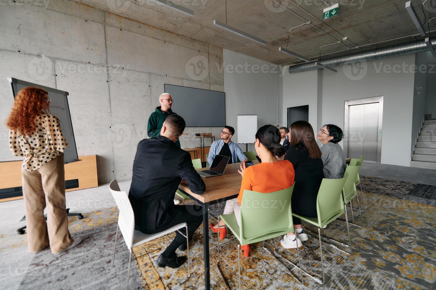 A diverse multiethnic business team engages in a collaborative meeting, discussing strategies and solutions in a modern office setting photo