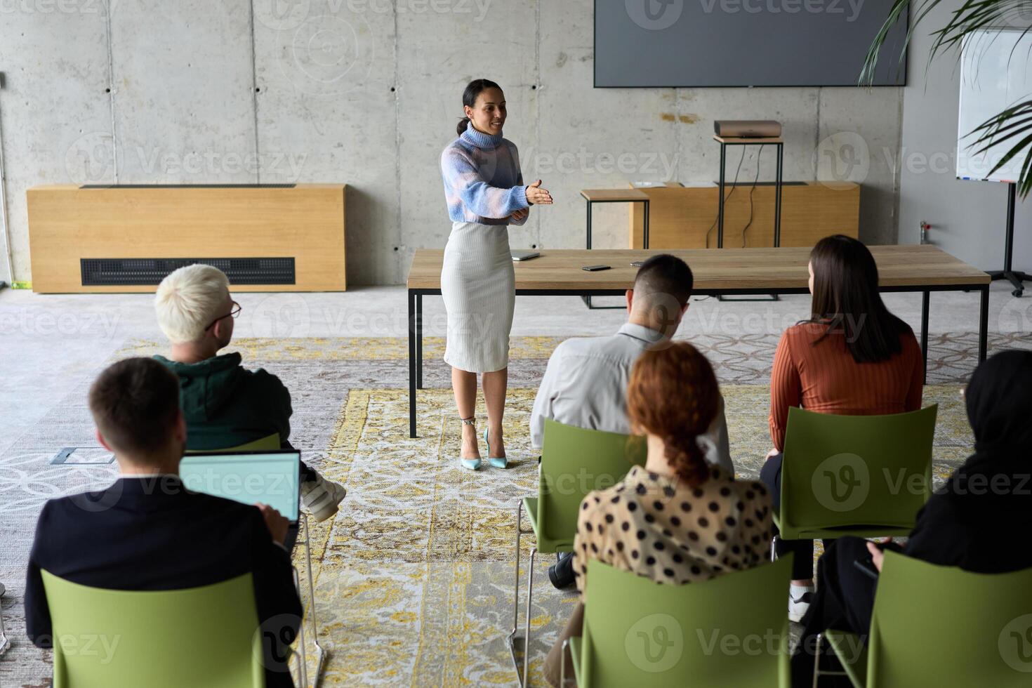 A businesswoman leader guiding a meeting with her colleagues, discussing business challenges, marketing strategies, and new plans for growth and success photo