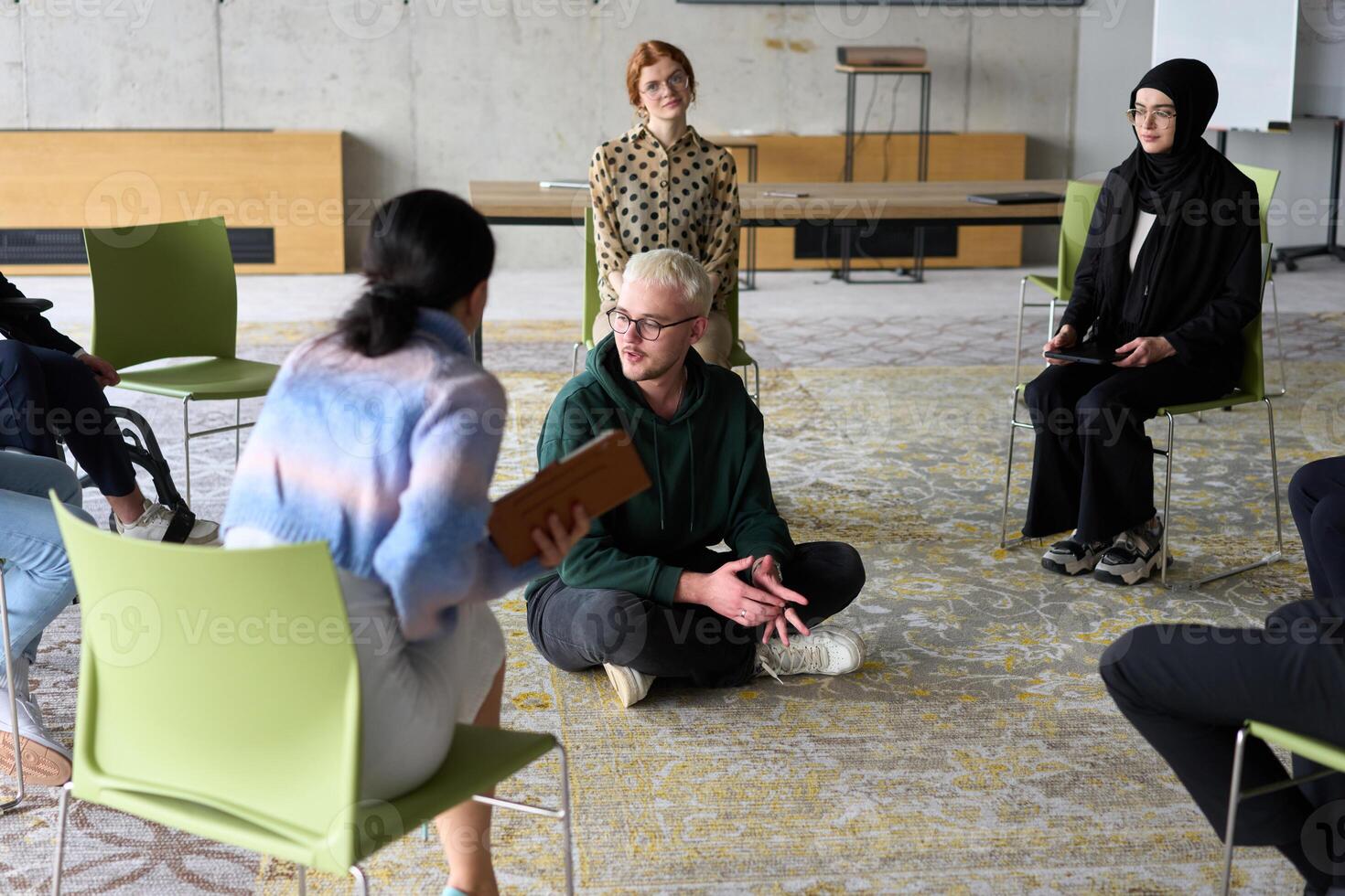Corporate business team meeting with a manager or coach. Group of happy diverse, multiracial people sitting in a circle photo