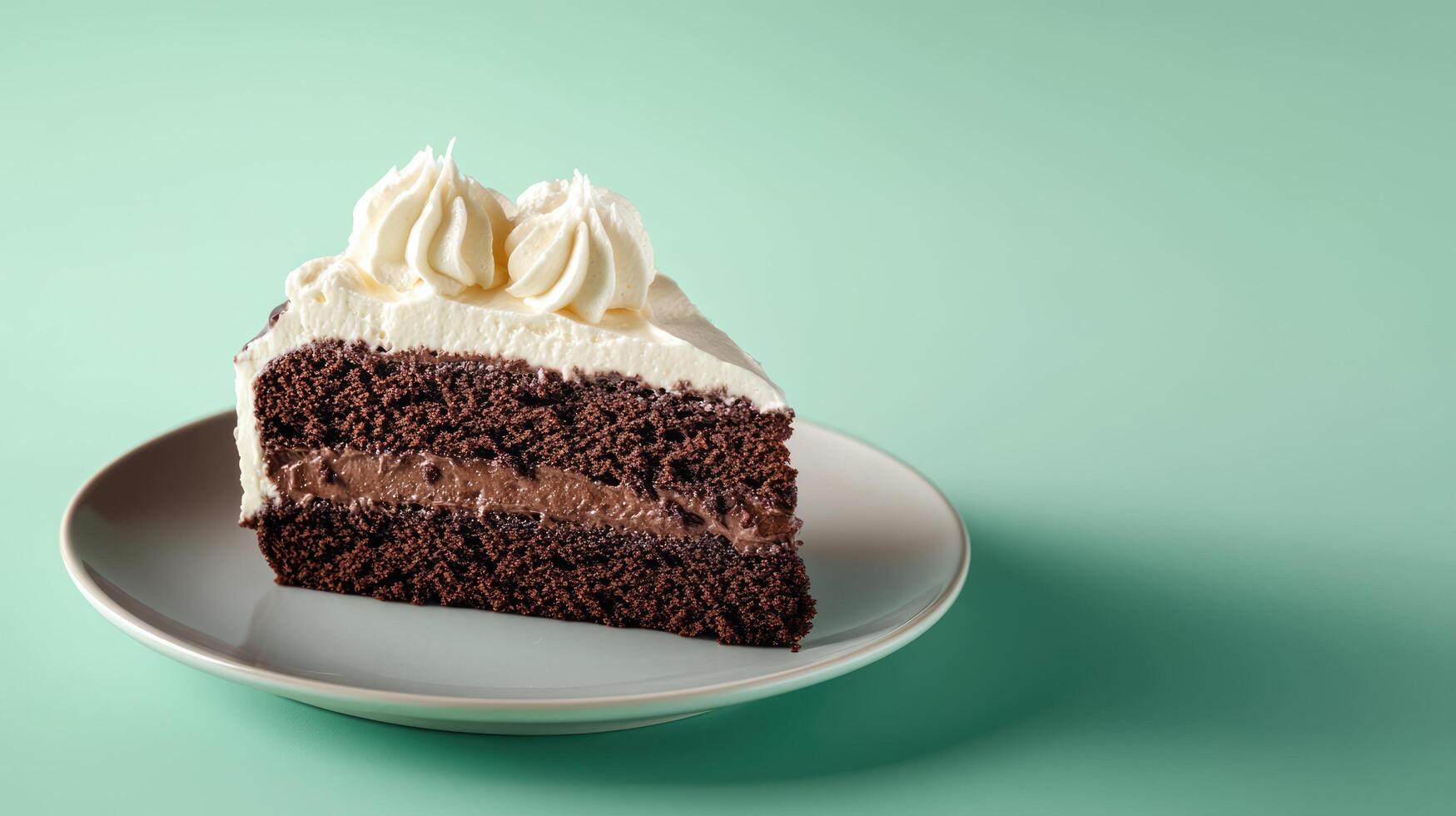 Piece of chocolate cake with vanilla cream on green pastel background with copy space photo