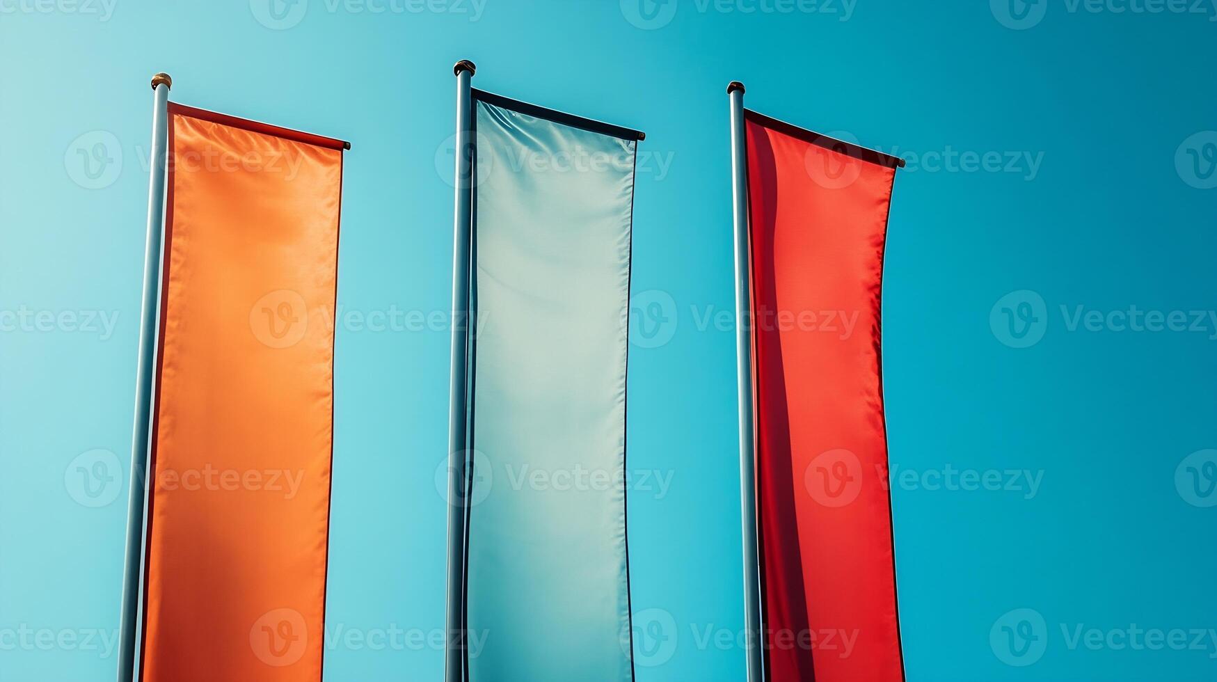 Three Colorful Hoisted Flags Against a Clear Blue Sky Signifying Unity and Diversity photo