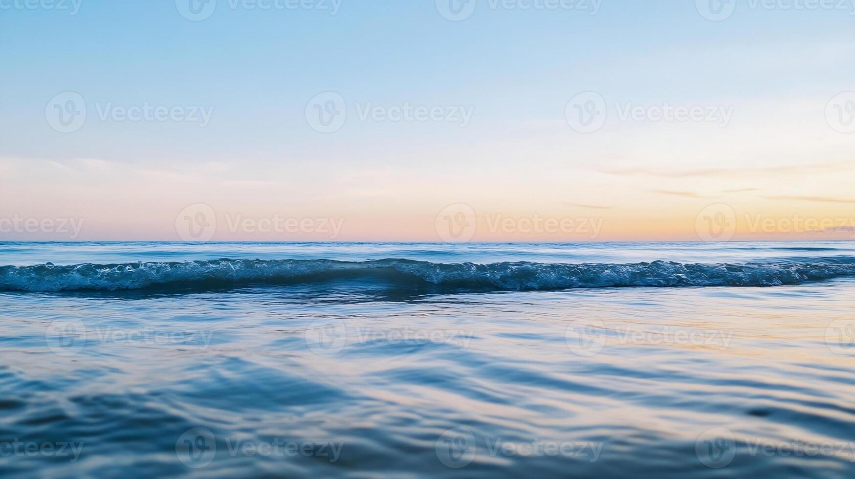 Serene Sunset Over Gently Rolling Ocean Waves with Clear Sky Reflection photo