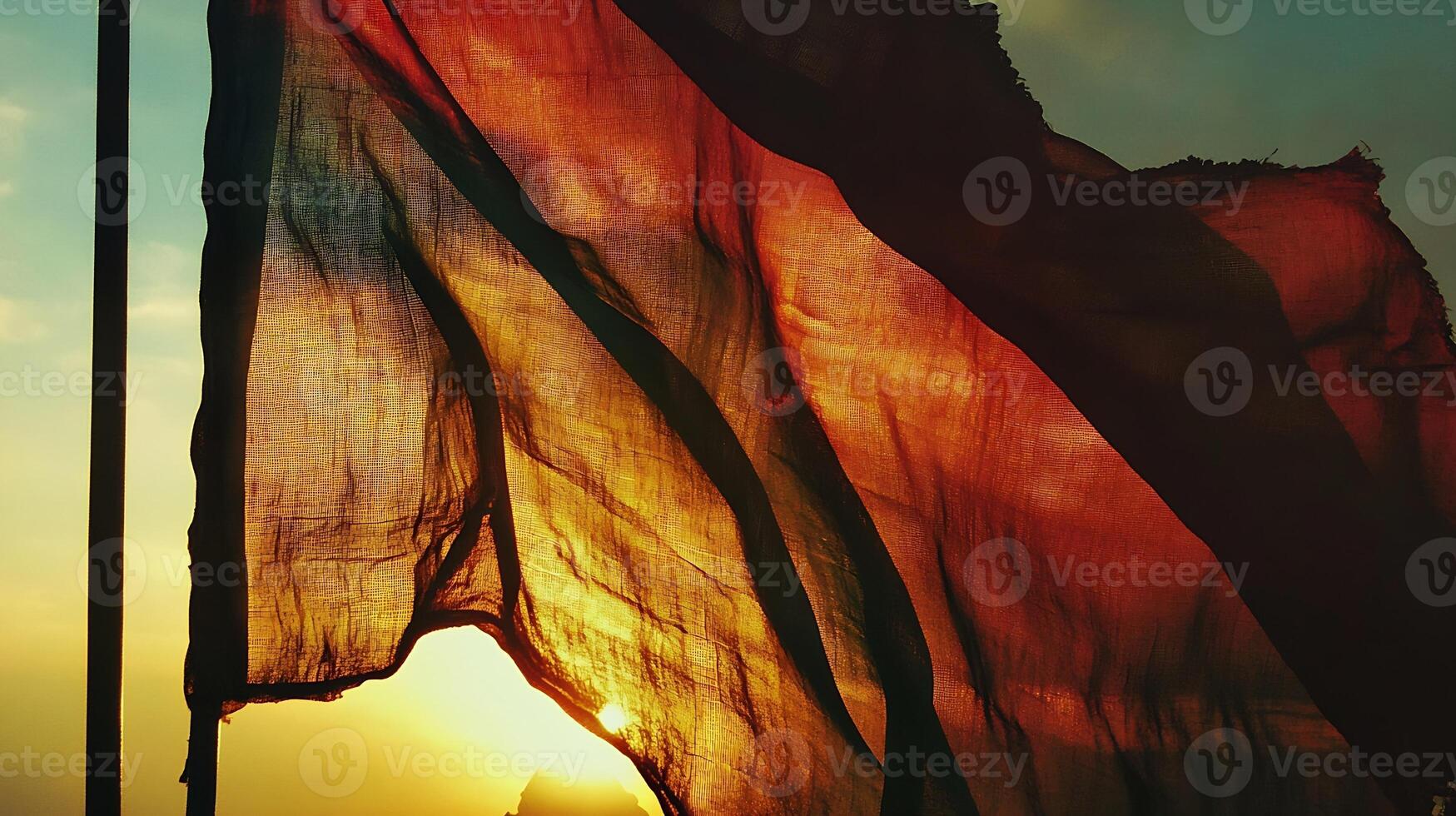 Tattered Indian Flag Silhouette Against a Stunning Sunset Sky photo