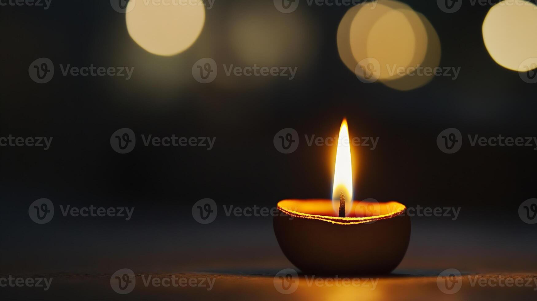 Serene Diya Candle Flame Glowing in Gentle Darkness with Soft Bokeh Lights photo