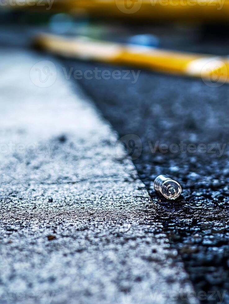 Close-up of Abandoned Bottle Cap on Textured Pavement Capturing Urban Decay photo