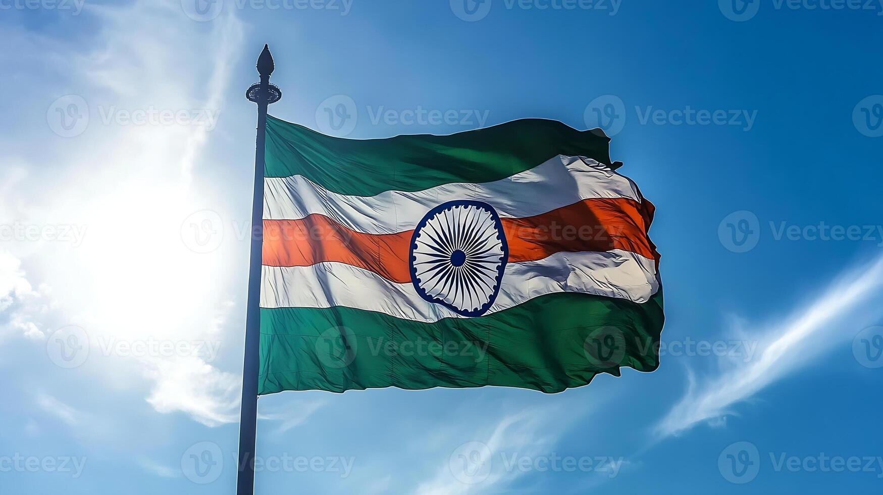 Indian National Flag Waving Elegantly Against a Bright Blue Sky and Radiant Sun photo