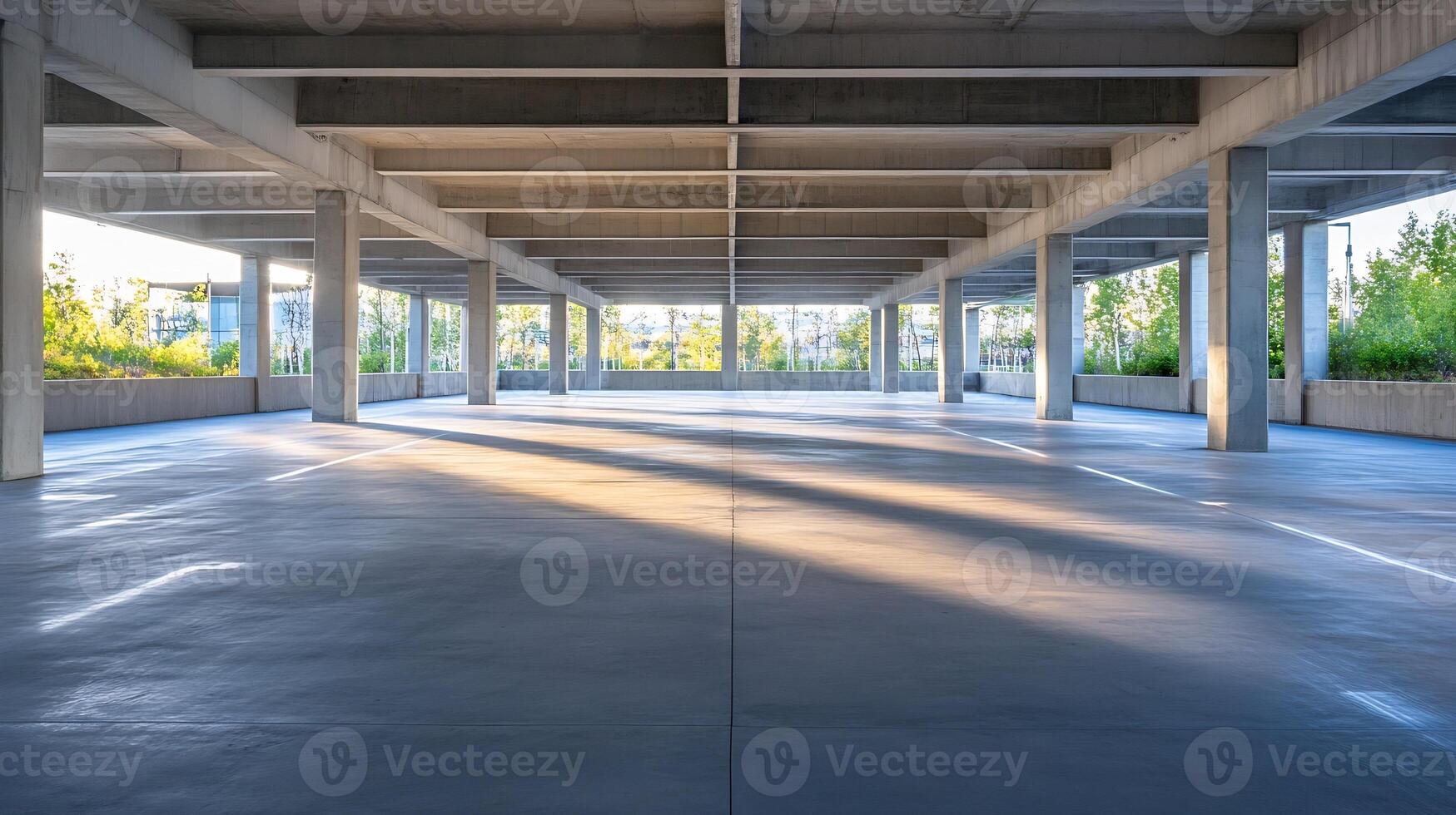 Bright open empty parking garage with sunlight and greenery photo