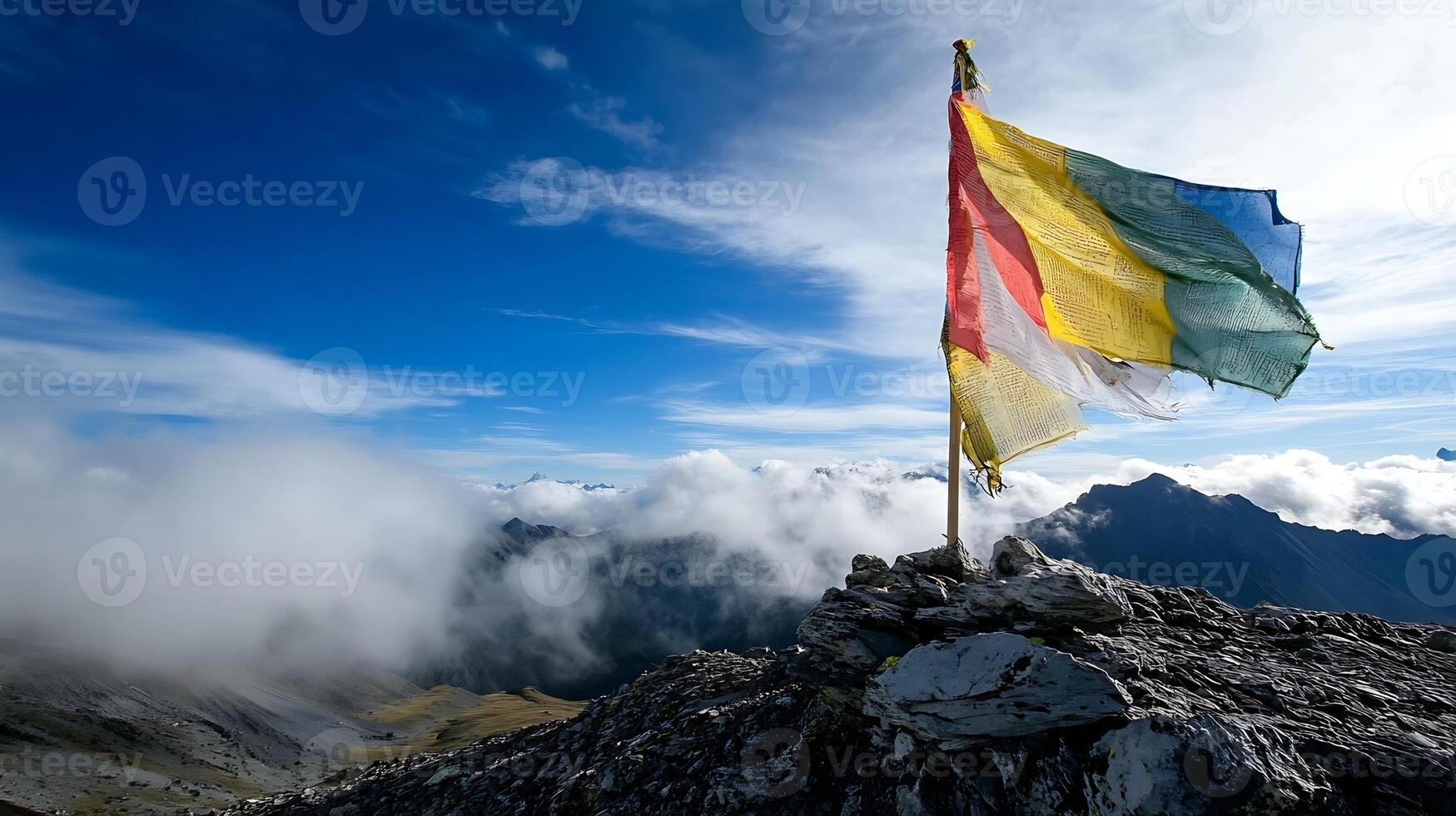 Tibetan Prayer Flags on Mountain Summit Amidst Clouds and Azure Blue Sky photo