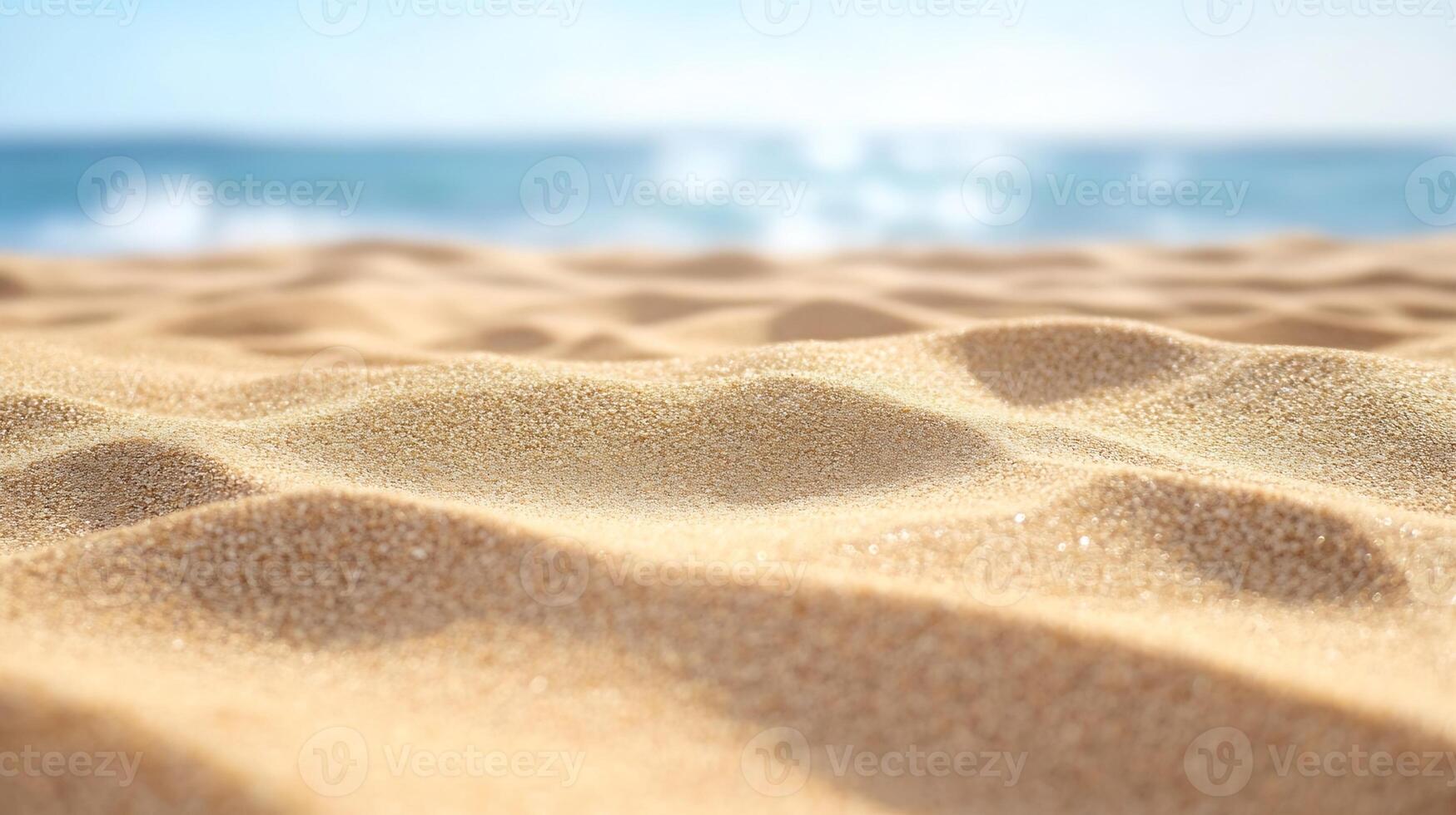 Close Up of Fine Golden Sand with Blurred Ocean Background photo